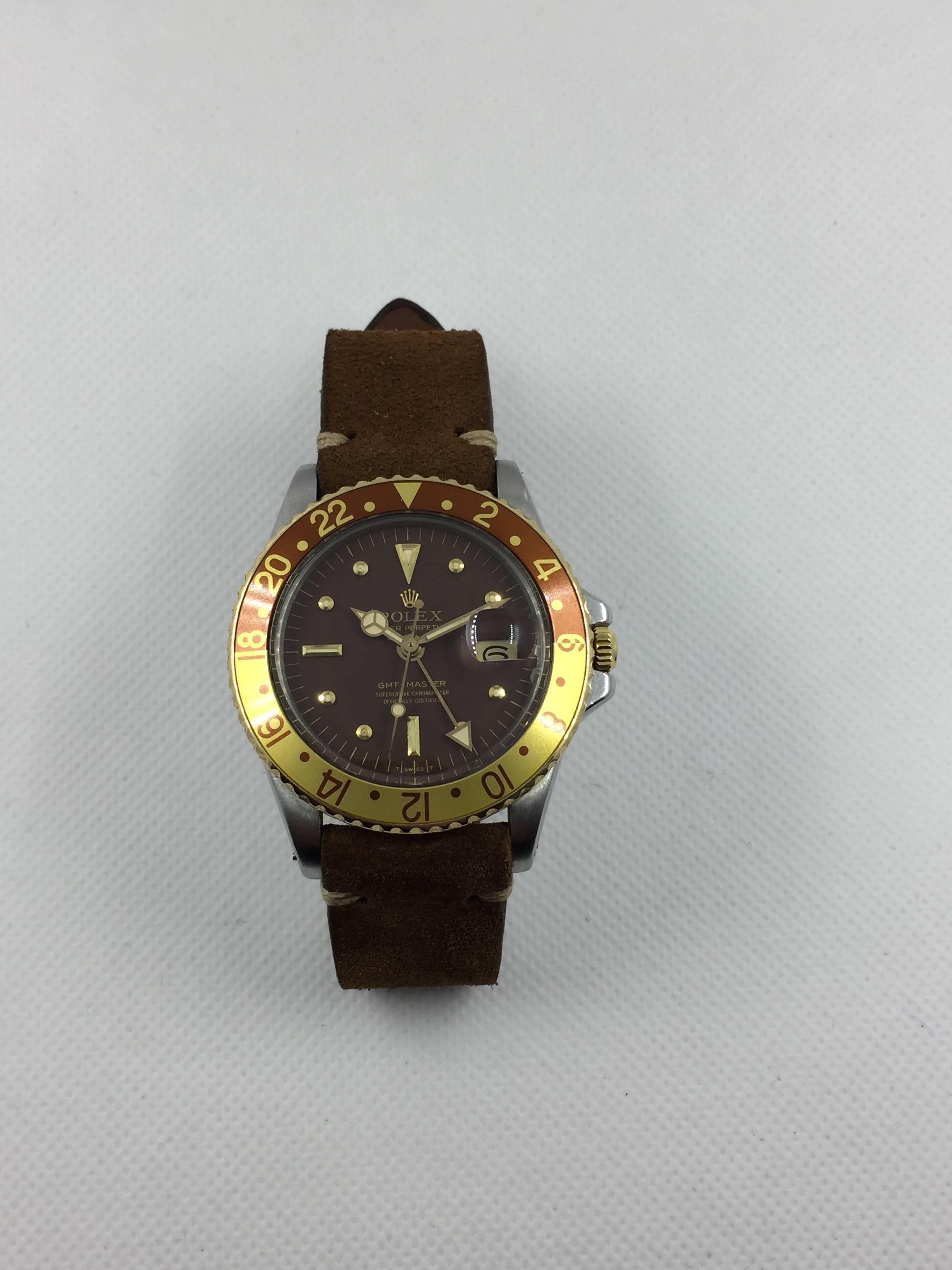 Rolex Stainless Steel and Yellow Gold Oyster Perpetual GMT Master Wristwatch
Factory Brown Nipple Dial with Applied Rolex Crown. Dial Shows Minor Wear and Breakdown Around Perimeter.
Yellow Gold Rotating Bezel with 'Rootbeer' Brown and Yellow