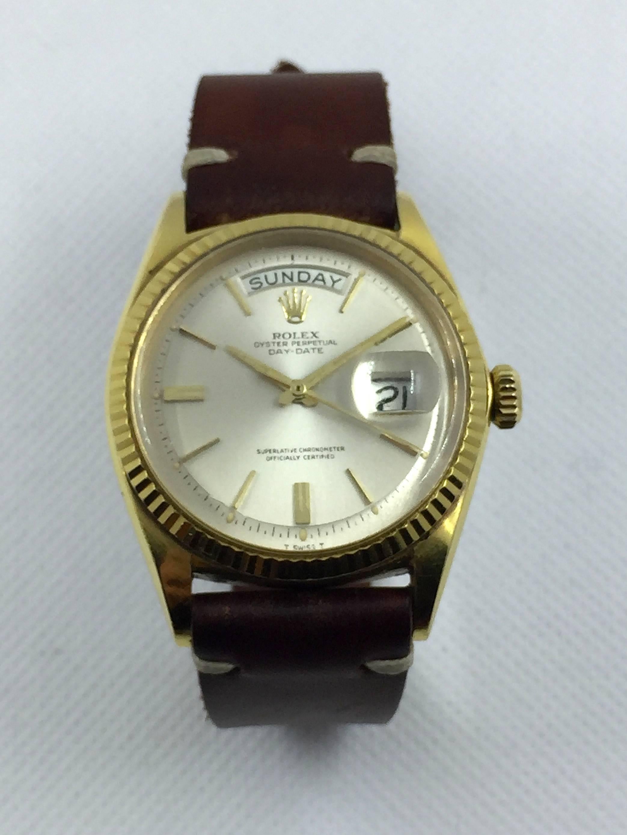 Rolex 18K Yellow Gold Oyster Perpetual Day-Date Wristwatch
Factory Silvered Pie-Pan Dial with Door-Step Markers at Six and Nine
Yellow Gold Fluted Bezel
36mm in size 
Day and Date Functions
Rolex Calibre Base 1500 Automatic Movement
Acrylic