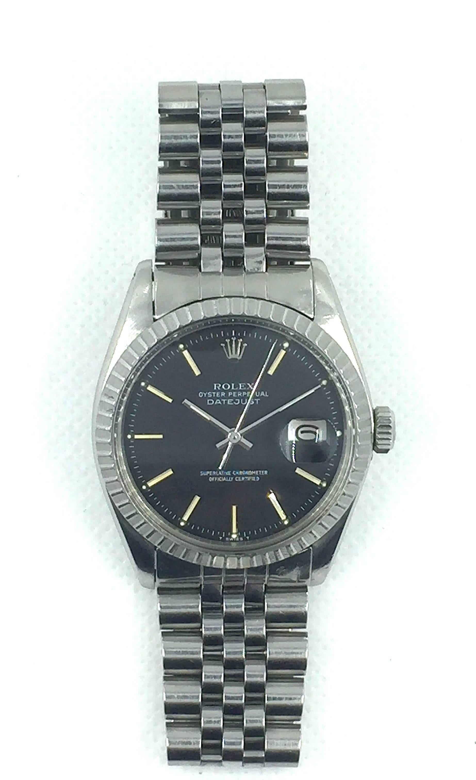 Rolex Stainless Steel Oyster Perpetual Datejust Wristwatch
Factory Black Matte Dial with Applied Bi-Tonal Hour Markers
Stainless Steel Engine-Turned Bezel
36mm in size 
Rolex Calibre Base 1500 Automatic Movement
Acrylic Crystal
Late 1970's