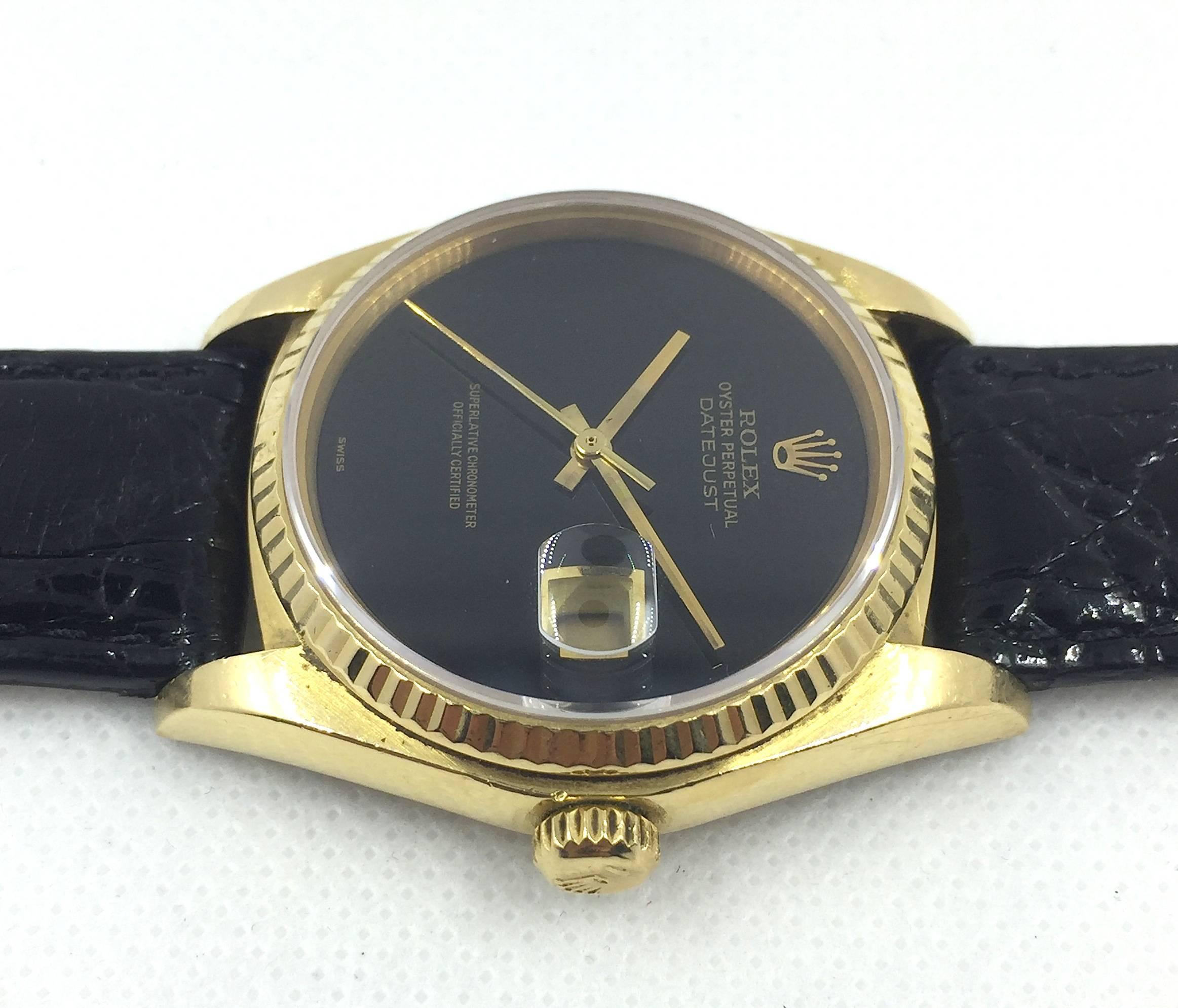Rolex 18K Yellow Gold Oyster Perpetual Datejust Wristwatch
Factory Black Onyx Stone Dial
18K Yellow Gold Fluted Bezel
36mm in size 
Rolex Calibre Base 3035 Automatic Movement
Sapphire Crystal
1980's Production
Comes Fitted on Handmade Black