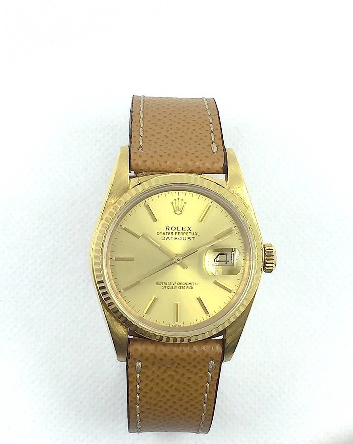 Rolex 18K Yellow Gold Oyster Perpetual Datejust Wristwatch
Factory Champagne Dial with Applied Stick Numeral Markers
18K Yellow Gold Fluted Bezel
36mm in size 
Rolex Calibre Base 3035 Automatic Quick-Set Movement
Sapphire Crystal
1980's