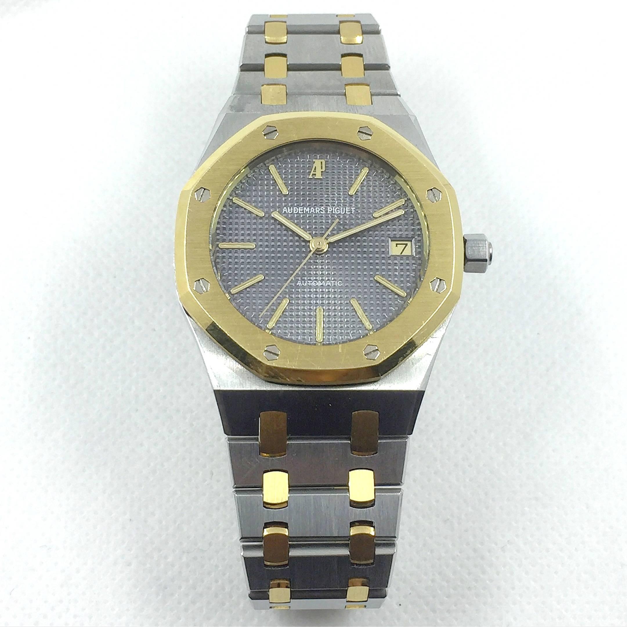Audemars Piguet Royal Oak Automatic Wristwatch
Stainless Steel and 18K Yellow Gold Case
35MM 
18K Yellow Gold Bezel
Stainless Steel and 18K Yellow Gold Integrated Bracelet with Audemars Piguet Signature Clasp
Factory Grey Waffle Dial with Applied