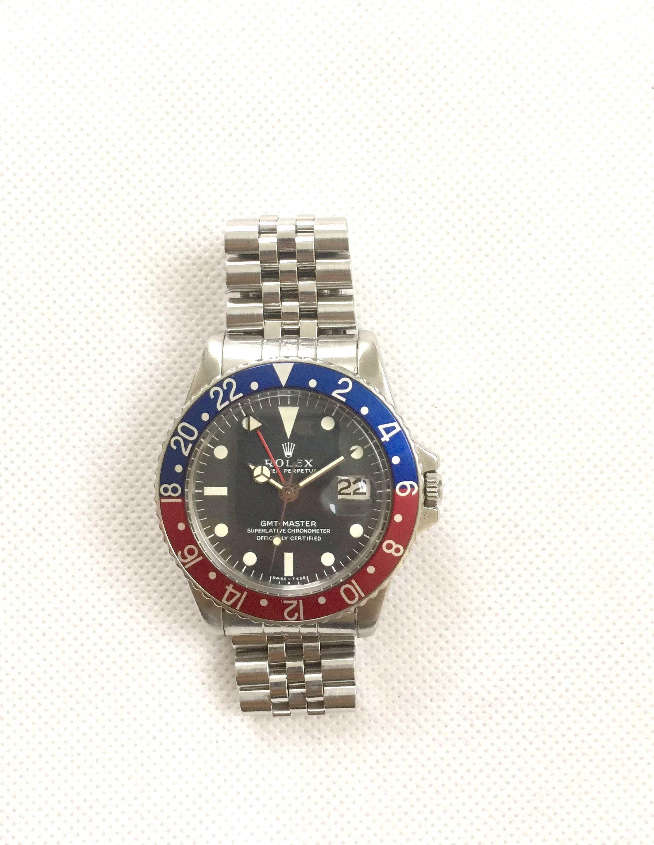 Rolex Stainless Steel Oyster Perpetual GMT Master Wristwatch
Reference 1675
Factory Black Matte Dial with White Toned Hour Markers and Matching Hands
Factory Blue and Red 'Pepsi" Bezel (Rotates Bi-Directional)
40mm in size 
Rolex Calibre Base