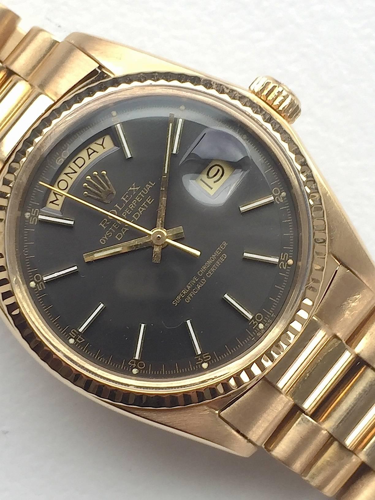 Rolex 18K Yellow Gold Day-Date Presidential Watch from the Early 1970's
Beautiful Factory Tungsten Grey Minute Track Dial with Applied Yellow Hour Markers 
Yellow Gold Gold Fluted Bezel
18K Yellow Gold Case
36mm in size 
Features Rolex Automatic