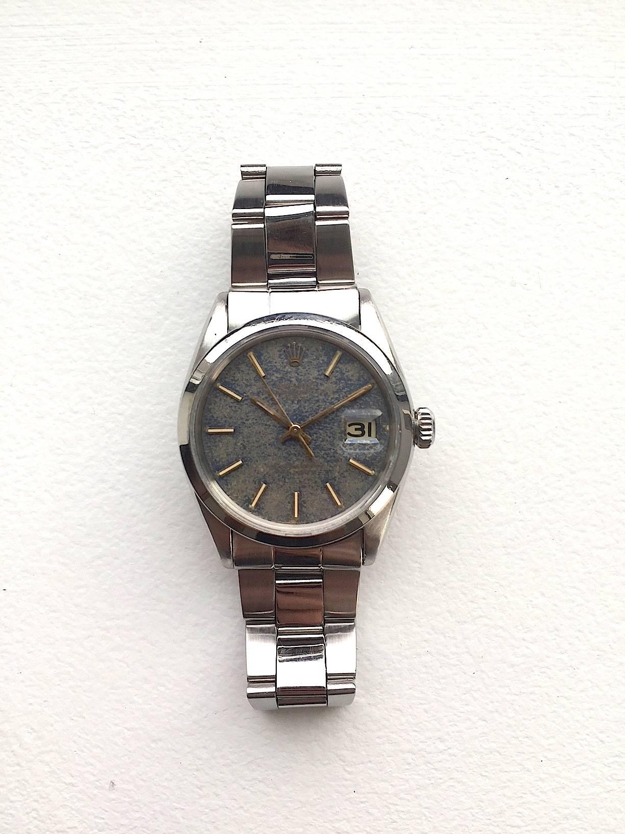 Rolex Stainless Steel Oyster Perpetual Date Watch
Rare One Of A Kind Blue Tropical Two Tone Dial with Yellow Applied Hour Markers and Matching Hands
Stainless Steel Smooth Bezel
Stainless Steel Case
34mm in size 
Features Rolex Automatic Movement