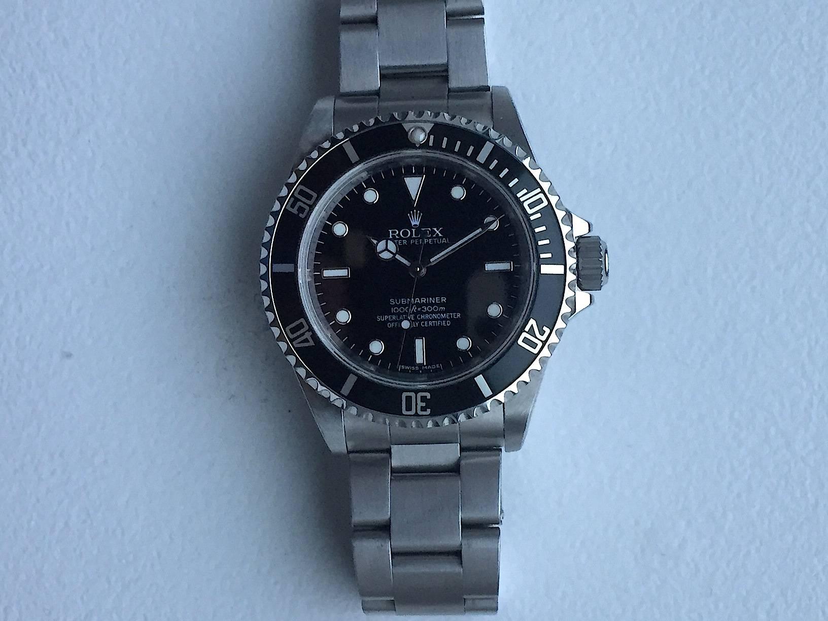 Rolex Stainless Steel Oyster Perpetual Submariner Superlative Chronomter Writwatch
Factory Black Gloss Dial with Luminous Markers
Black Rotating Bezel
40mm in Size
Chronometer Movement
Inner Engraved Bezel
Rolex Calibre 3130M Movement 
Sapphire