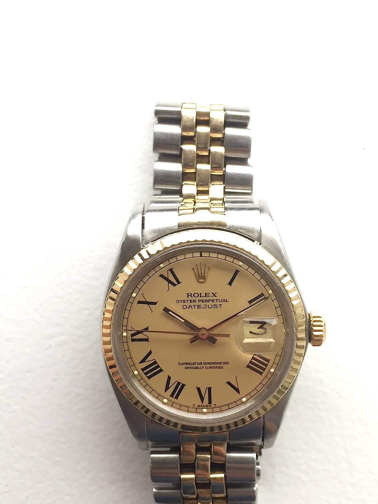 Rolex Stainless Steel and Yellow Gold Oyster Perpetual Datejust Wristwatch
Beautiful Factory Champagne 'Buckley' Dial with Black Roman Numeral Hour Markers
Yellow Gold Gold Fluted Bezel
Stainless Steel Case
36mm in size 
Features Rolex Automatic