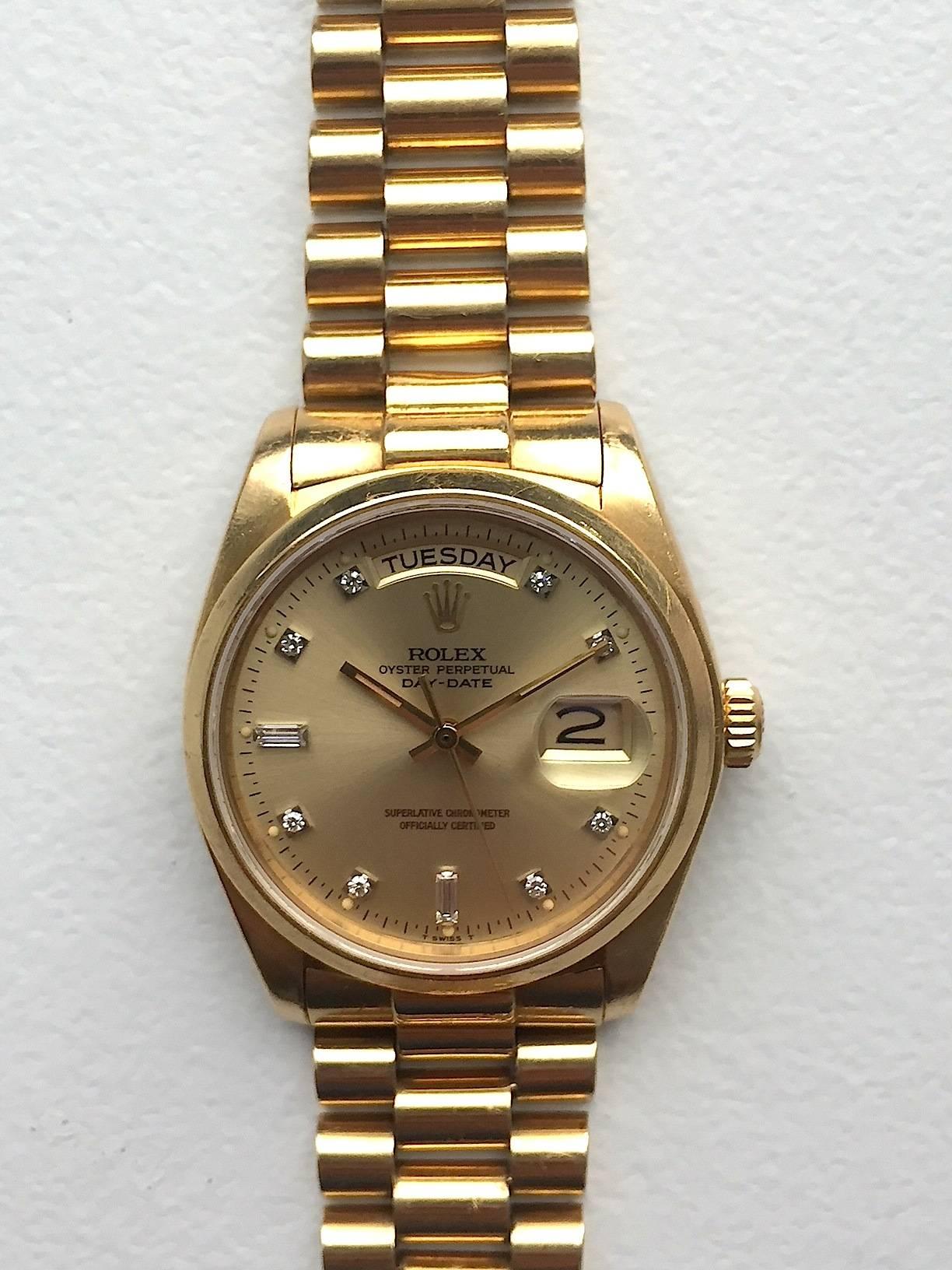 Rolex 18K Yellow Gold Oyster Perpetual Automatic Day-Date Wristwatch 
Beautiful Factory Champagne Diamond Dial with Diamond Hour Markers
Rare Rolex Reference from Late 1970's with Smooth 18K Yellow Gold Bezel
18K Yellow Gold Case
36mm in size