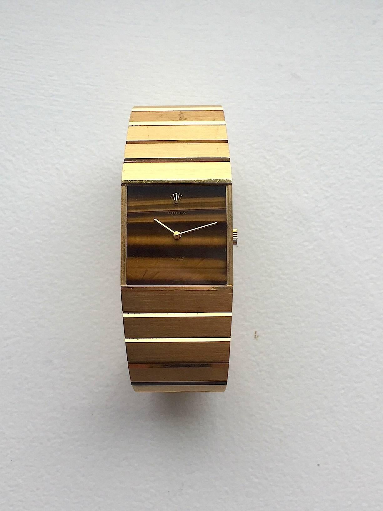 Rolex 18K Yellow Gold King Midas Tiger's Eye Manual Wind Wristwatch
Beautiful Factory Tiger's Eye Stone Dial
Solid 18K Yellow Gold Case
25mm x 35mm
Features Rolex Manual Wind Movement
Sapphire Crystal
From Early 1970's
Features a Solid Rolex 18K