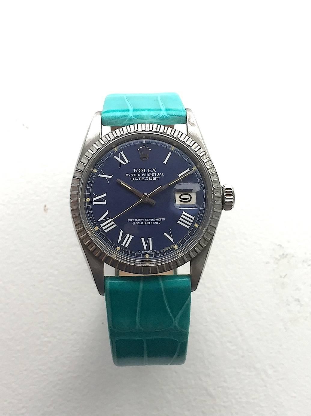 Rolex Stainless Steel Oyster Perpetual Datejust Watch
Factory Blue Buckley Dial with White Roman Numeral Hour Markers
Stainless Steel Engine-Turned Bezel
Stainless Steel Case
36mm in size 
Features Rolex Automatic Movement with Calibre 1570 with