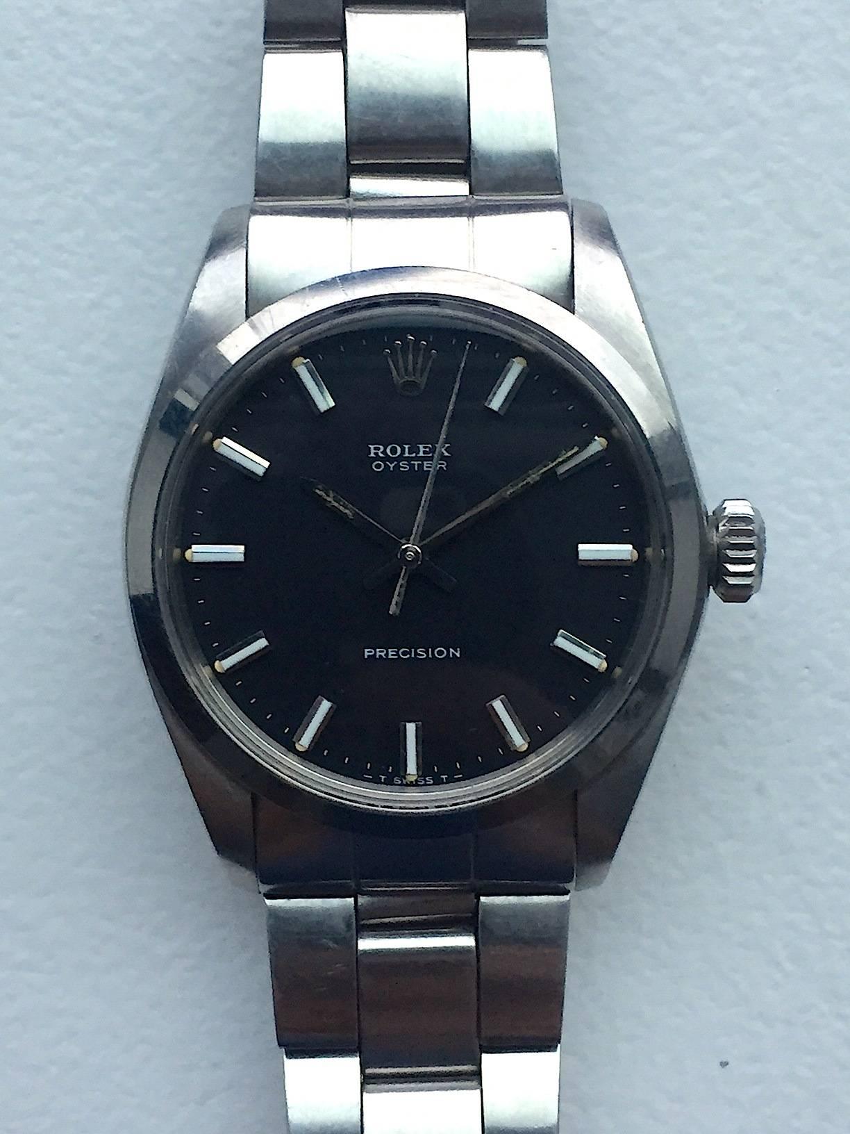 Rolex Stainless Steel Oyster Precison Manual Wind Wristwatch
Rare Black Matte T Swiss T Dial with Applied Hour Markers 
Stainless Steel Smooth Bezel
Stainless Steel Case
34mm in size 
Features Rolex Manual Wind Movement
Acrylic Crystal
From 