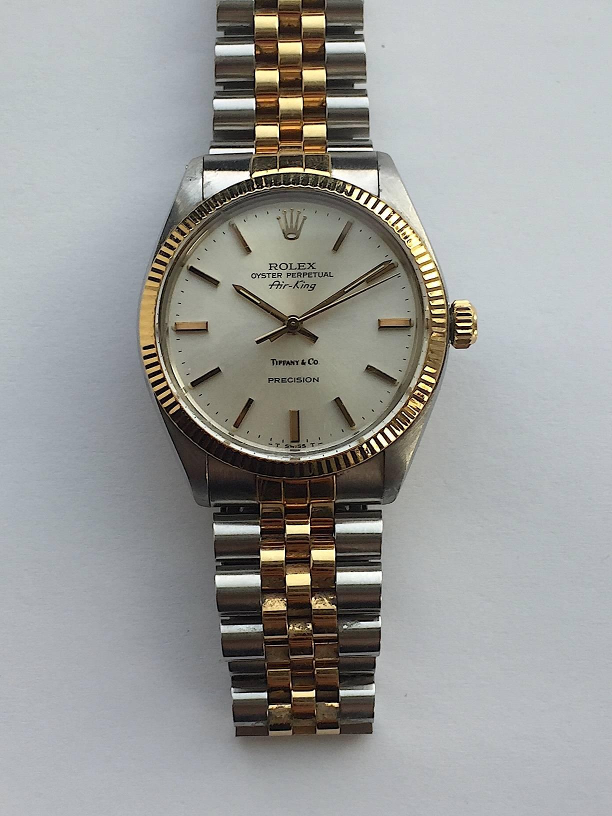 Rolex Stainless Steel and Yellow Gold Oyster Perpetual Air-King Watch
Beautiful Factory Silver Dial Marked Tiffany & Co. 
This Watch Was Originally Retailed At Tiffany & Co.
Yellow Gold Gold Fluted Bezel
Stainless Steel Case
34mm in size 
Features