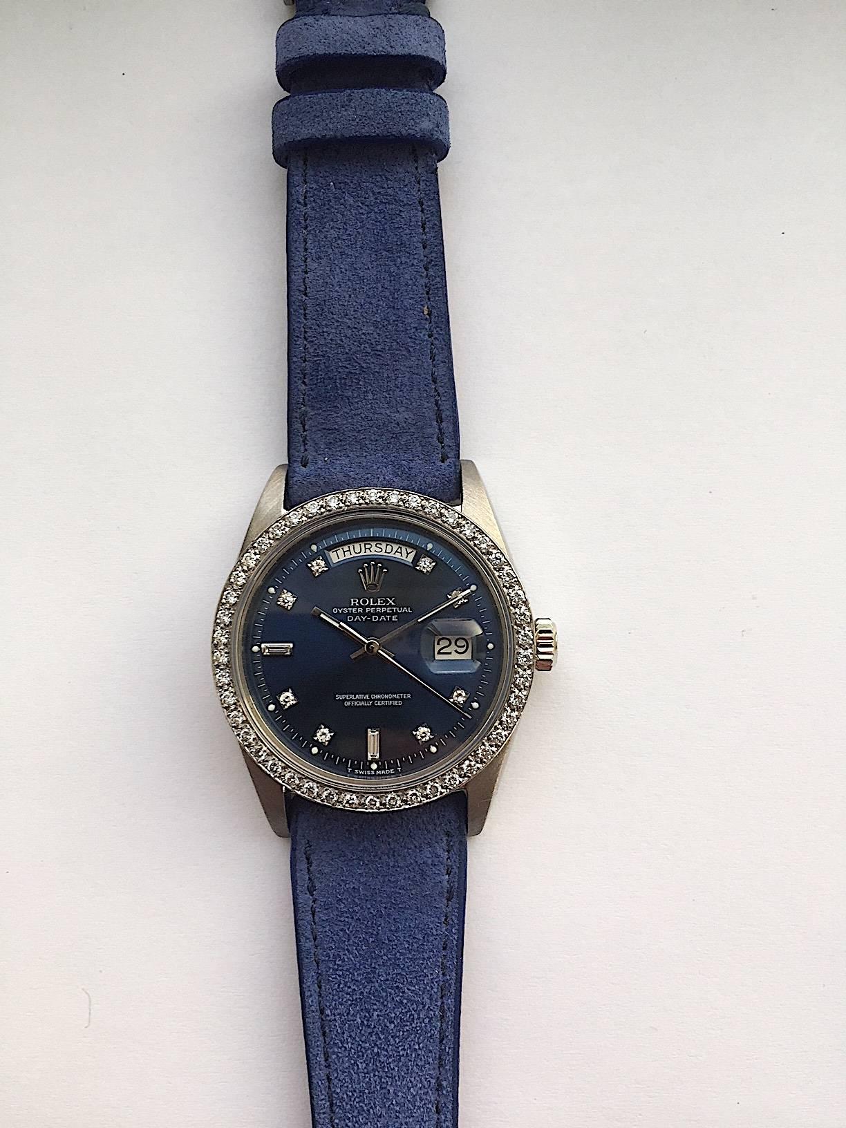 Rolex 18K White Gold Oyster Perpetual Day-Date Watch
Beautiful Rolex Factory Blue Diamond Dial with Matching Factory 18K White Gold Diamond Bezel
Rare Rolex 18K White Gold Model from the 1970s
18K White Gold Case
36mm in size 
Features Rolex