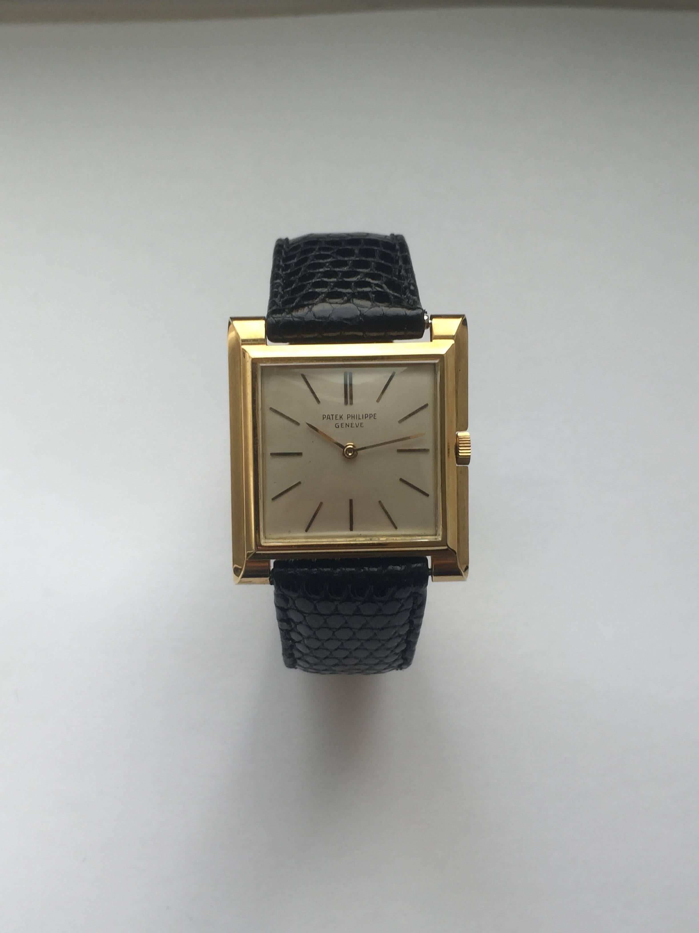 Patek Philippe 18K Yellow Gold Square Vintage Manual Wind Watch
Factory Original Silver Toned Dial with Applied Gold Colored Hour Markers
18K Yellow Case
32mm x 28mm
Patek Philippe Manual Wind Movement 
Acrylic Crystal
Circa Late 1950's
Engraved