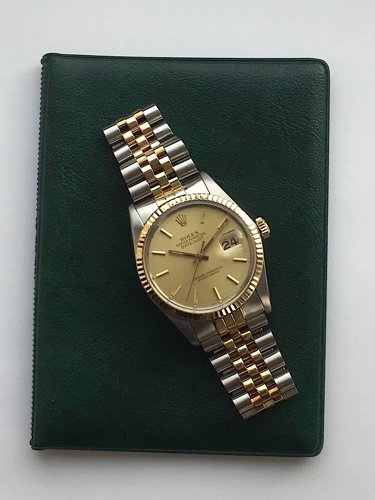 Rolex Stainless Steel and Yellow Gold Oyster Perpetual Datejust Watch
Factory Champagne Dial with Applied Hour Markers
Yellow Gold Fluted Bezel
36mm in size 
Rolex Calibre Base 3035 Automatic Movement with Quick-Set Date Function
Acrylic