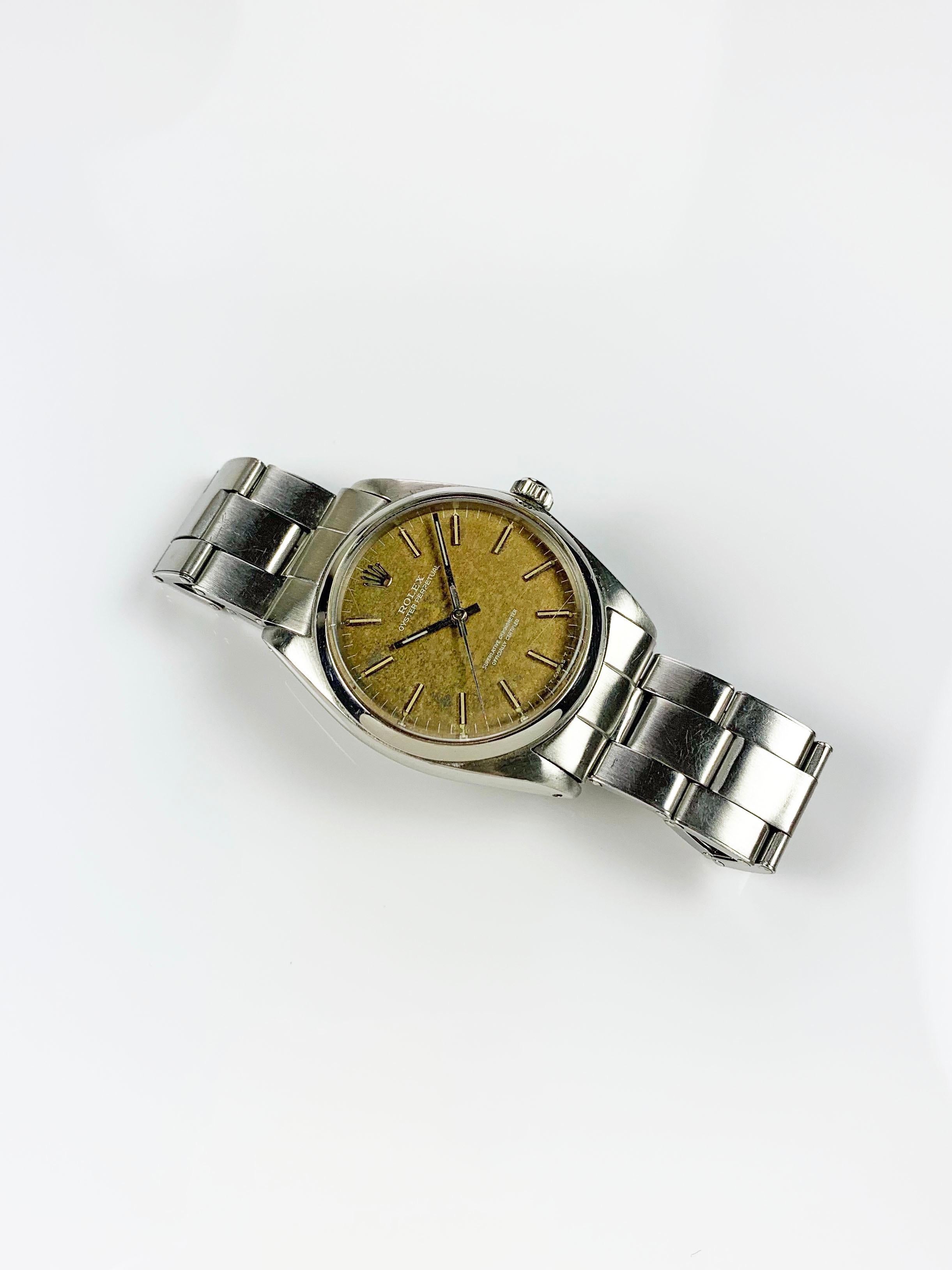 Rolex Stainless Steel Oyster Perpetual Wristwatch
Factory One-Of-A-Kind Tropical Dial
Dial Aged Naturally This Way
Stainless Steel Smooth Bezel
34mm in size 
Rolex Automatic Movement
Acrylic Crystal
1960s Production
Comes Fitted on Original Rolex