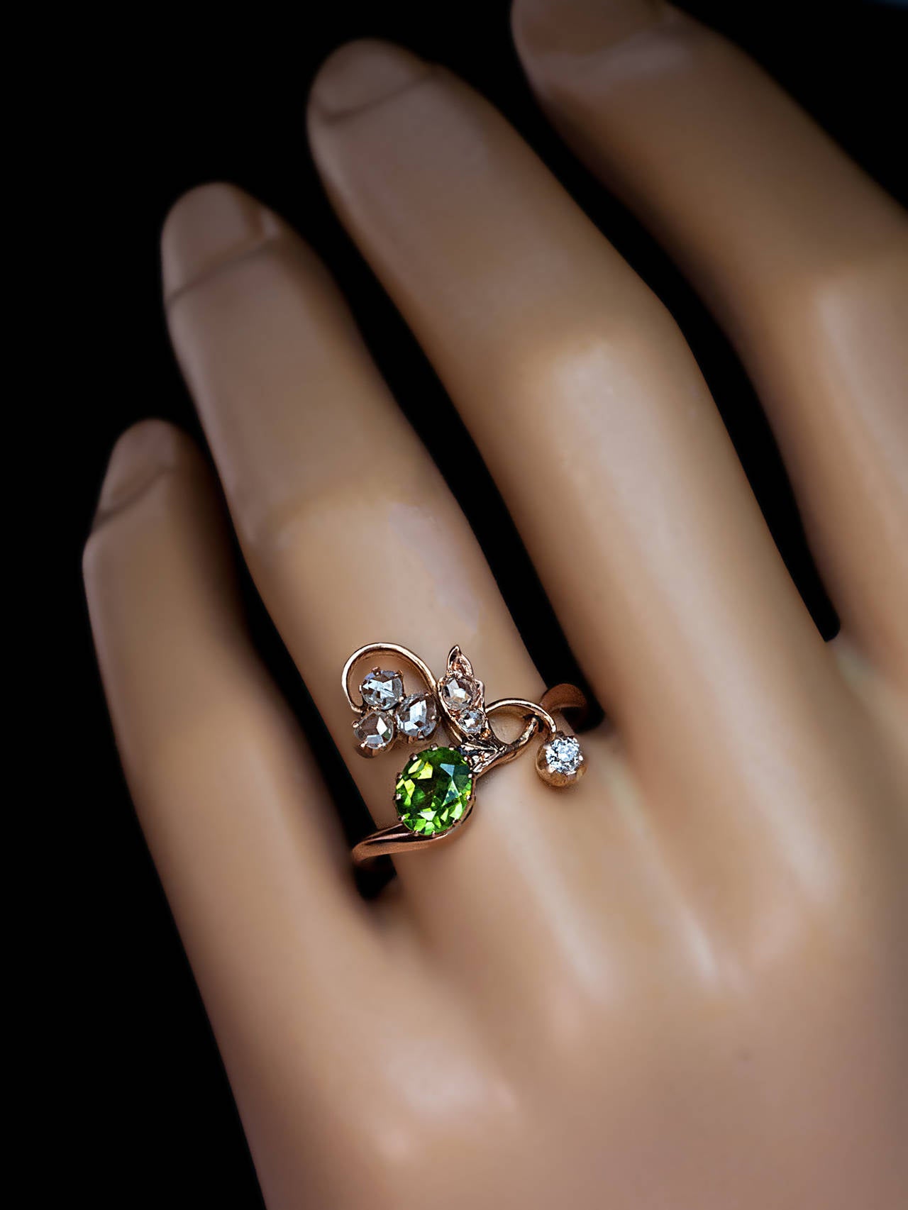 Made in Kazan between 1899 and 1908.

The ring features an excellent sparkling green 0.77 ct demantoid garnet with a superb well-defined 