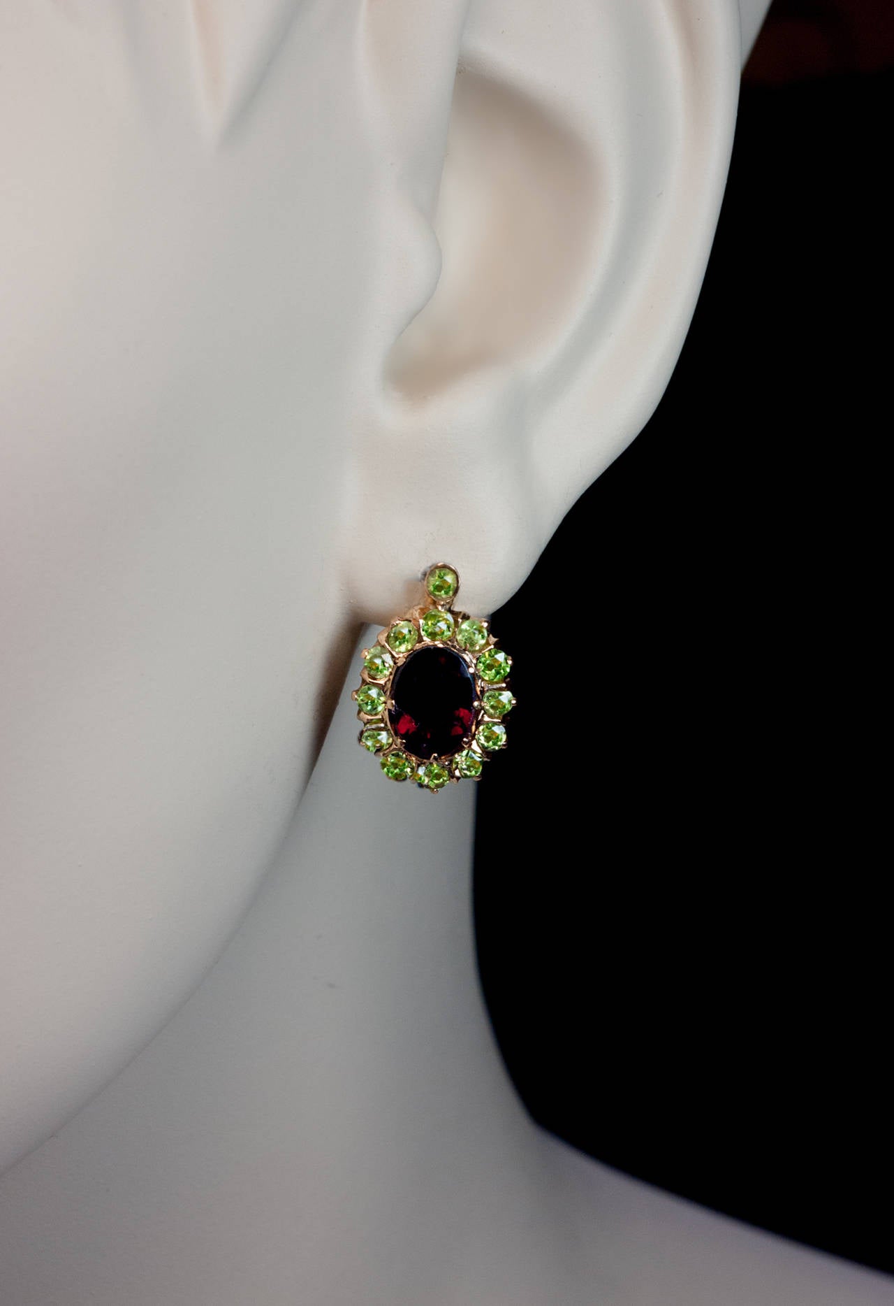 made in St. Petersburg between 1908 and 1917

 The cluster earrings are centered with oval dark red hessonite garnets surrounded by sparkling apple green demantoids.

 Marked with 56 zolotnik gold standard (14K) and maker's initials

 size of