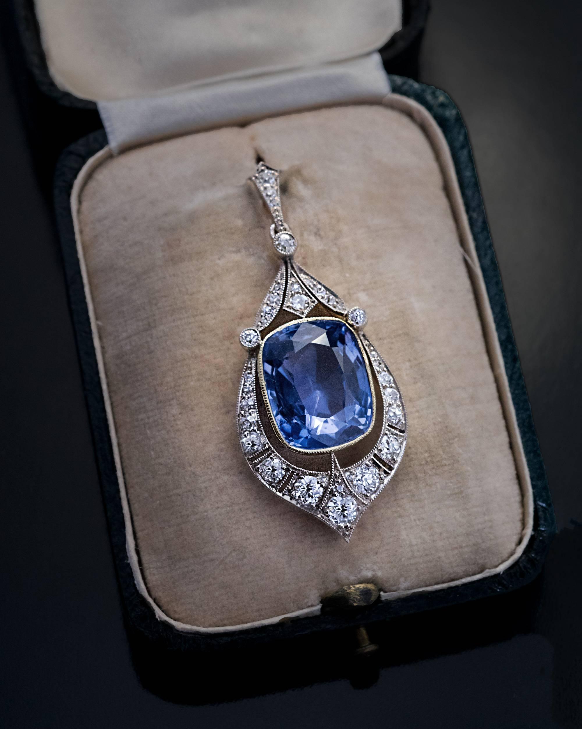 Made in Moscow around 1930
A vintage silver-topped 14K gold Art Deco pendant features an impressive 12.47 ct natural unheated sapphire from Ceylon. The sapphire is set in an elaborate frame embellished with transitional and old cut diamonds