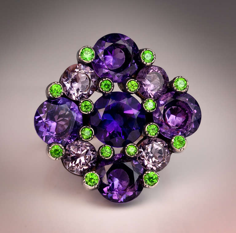 The ring is set with nine Russian amethysts - of deep purple, medium purple, and pale lavender color - and sixteen bright green demantoids.
 The stones are set in silver over 14K rose gold. 

The ring is marked with later Russian control