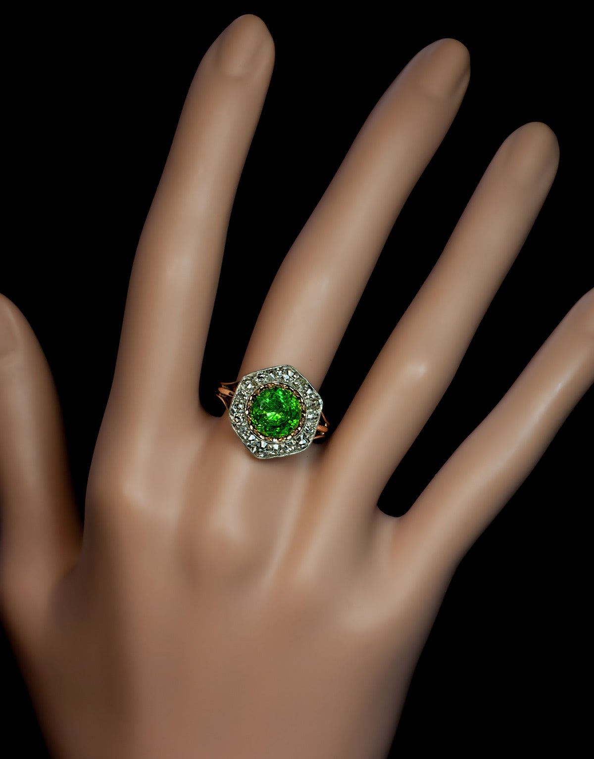 A Rare Almost 3 Carat Russian Demantoid and Diamond Ring made between 1908 and 1917.

The silver topped 14K gold ring features a very large vivid grass green 2.84 ct Russian demantoid (8.55 x 5.45 mm) prong-set in gold within a hexagonal frame