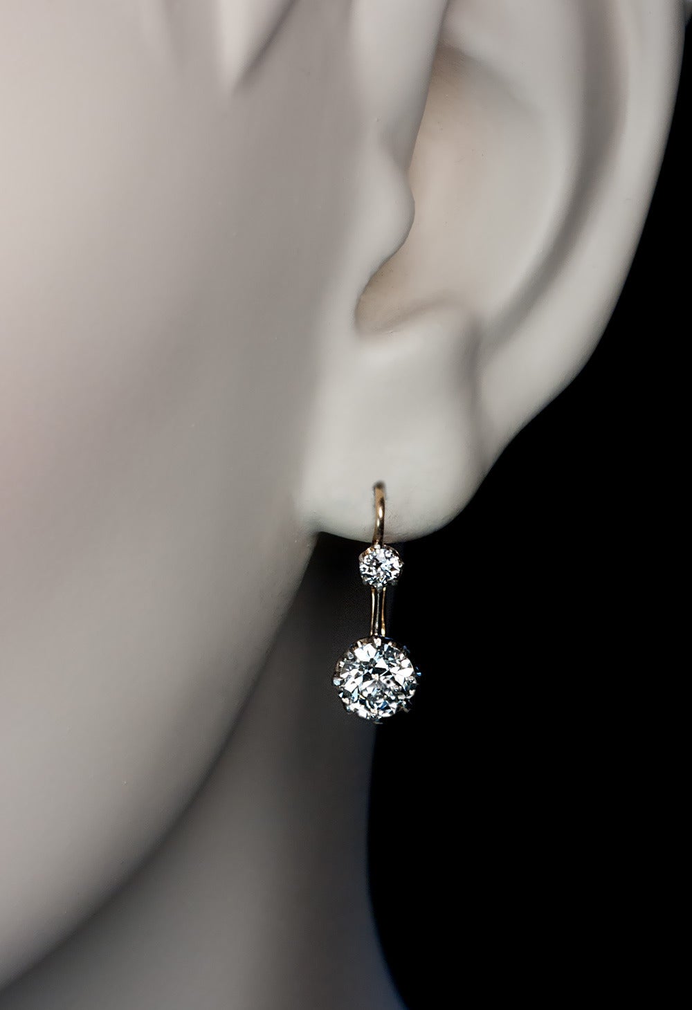 Circa 1910

The silver topped 14K gold leverback earrings are prong-set with four sparkling old European cut diamonds:

 0.85 ct, 0.87 ct, 0.11 ct and 0.11 ct

 Total diamond weight 1.94 ct

 Length with ear wire 19 mm (3/4 in.)