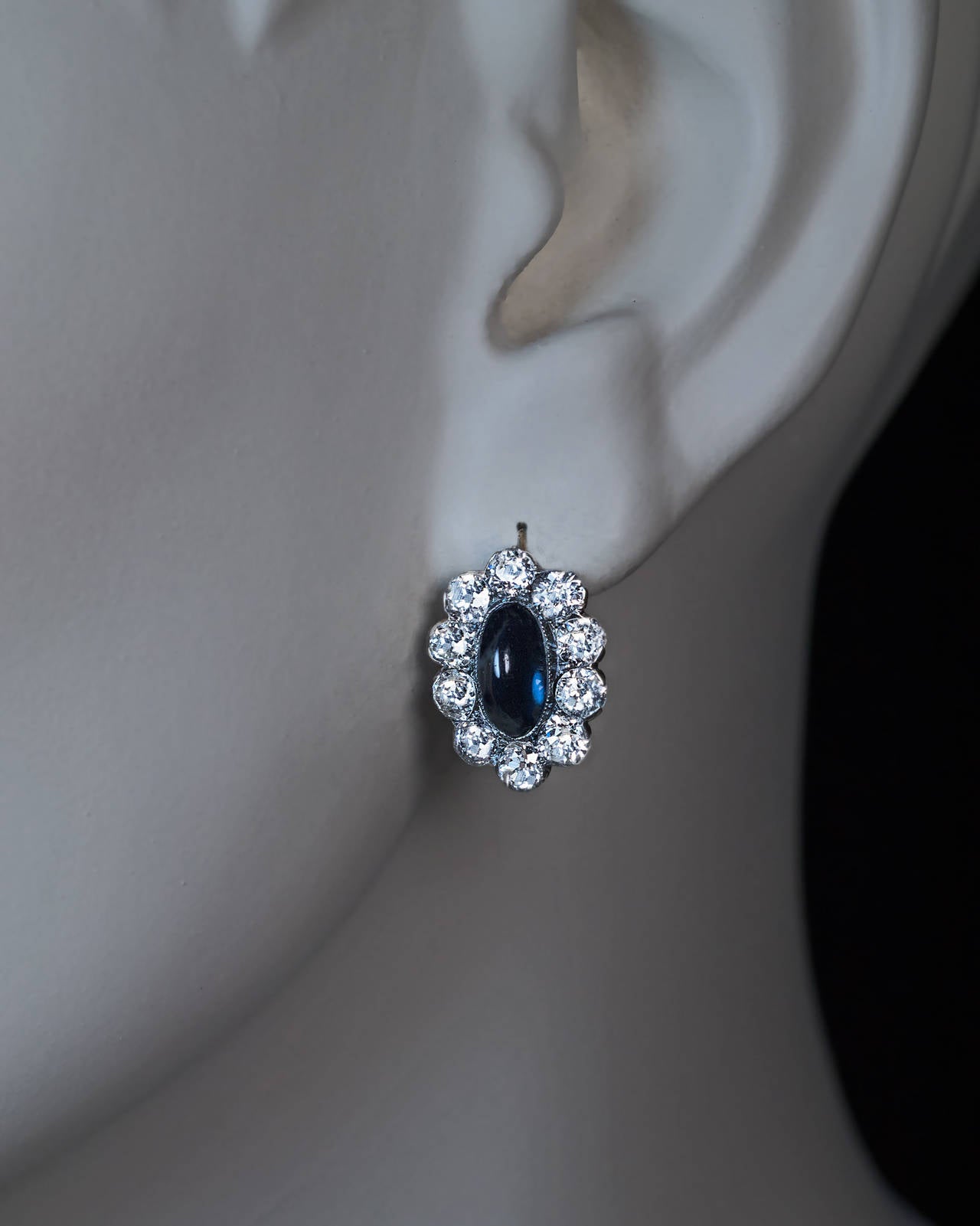 Russian, made in Kiev between 1908 and 1917

Silver and 14K gold, centered with cabochon cut sapphires surrounded by sparkling bright white old European cut diamonds

Marked with 56 zolotnik gold standard and maker's initials