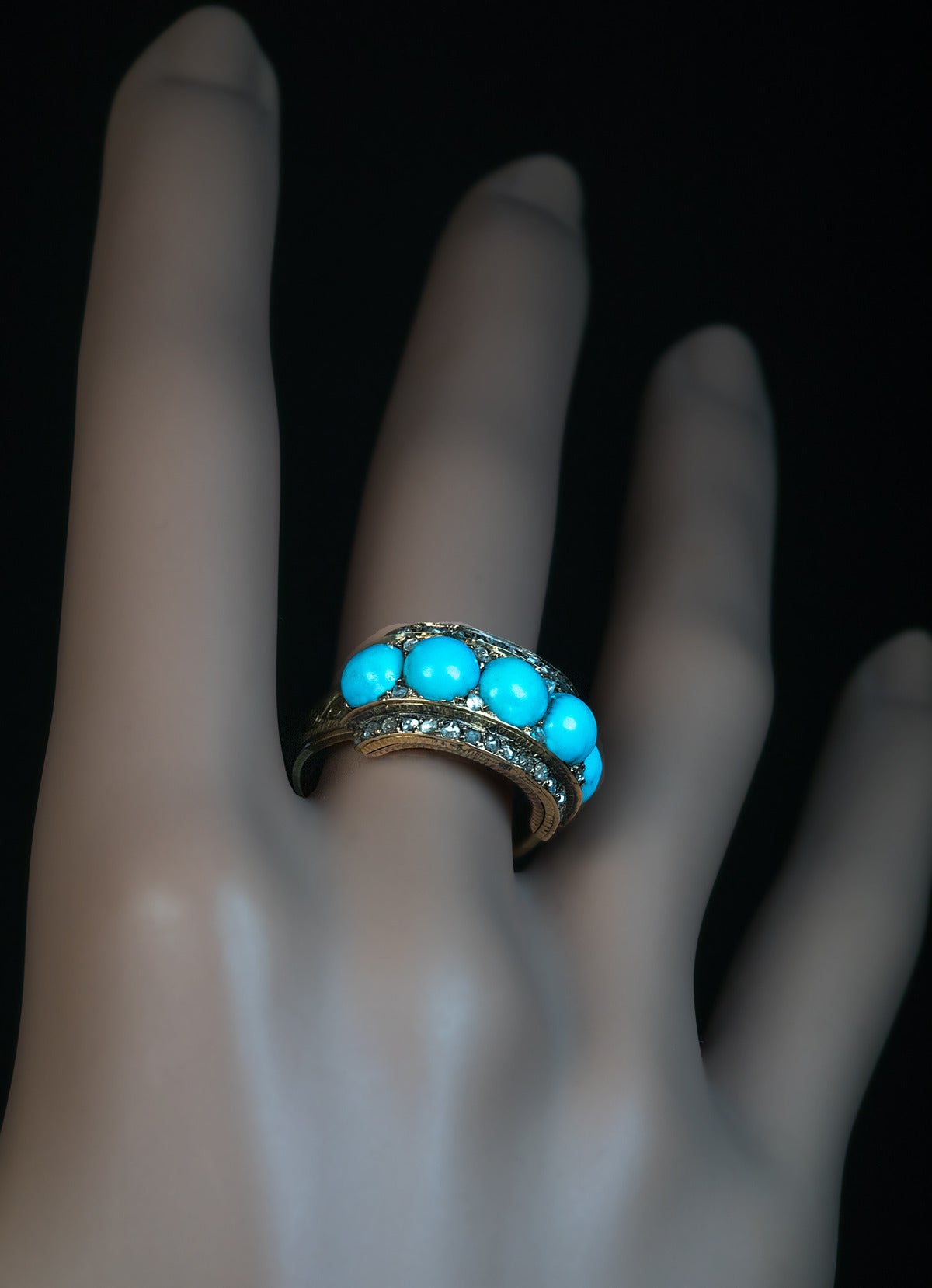 Five stone turquoise ring accented with numerous rose cut diamonds

Width 10 mm

Ring size 6.75