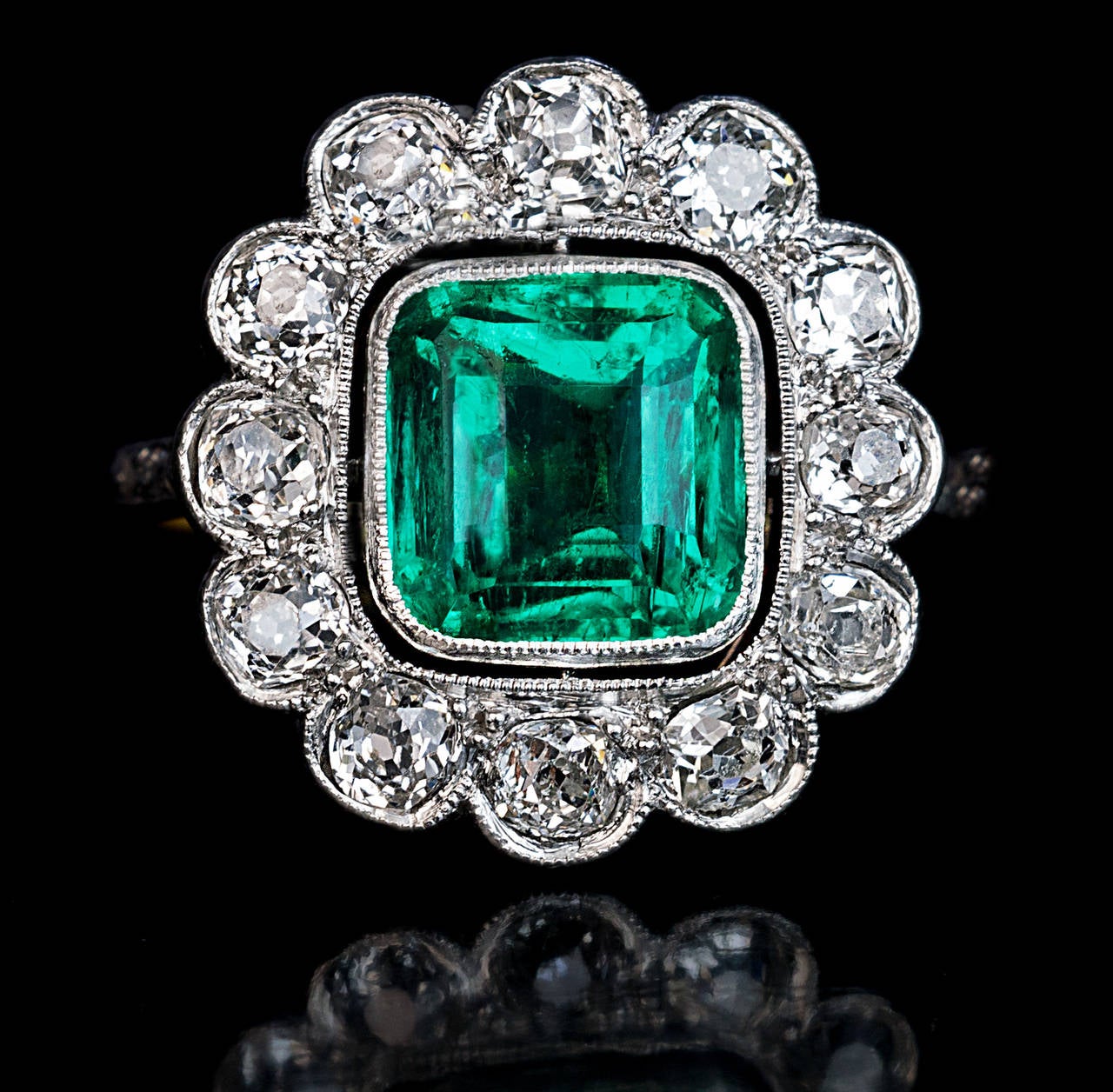 French, circa 1915

platinum over 18K gold, 
estimated emerald weight 2.25 ct, 
12 old European cut and 6 old rose cut diamonds - approximate total weight 1.30 ct

marked with maker's initials, eagle and dog shaped French marks for 18K gold