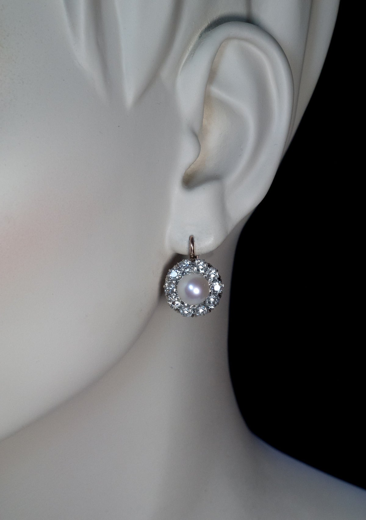 circa 1910

silver topped 14K rose gold earrings centered with 7.9 mm cultured pearls surrounded by antique cushion cut diamonds (H-I color, VS2-SI1 clarity)

estimated total diamond weight 3.80 ct

diameter 15 mm (5/8 in.)

marked with
