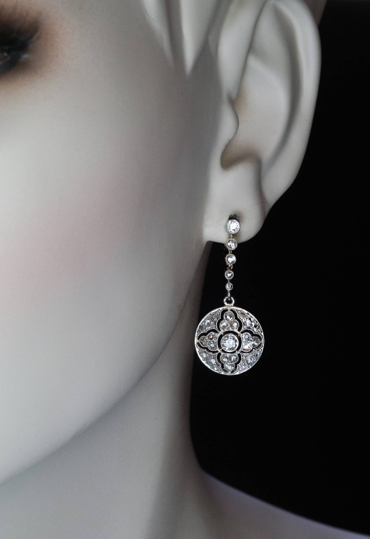 circa 1910

platinum topped gold earrings designed as openwork rosettes centered with old European cut diamonds surrounded by numerous old rose cut diamonds

estimated total diamond weight 1.20 ct

total length 33 mm (1 3/8 in.)

diameter 15
