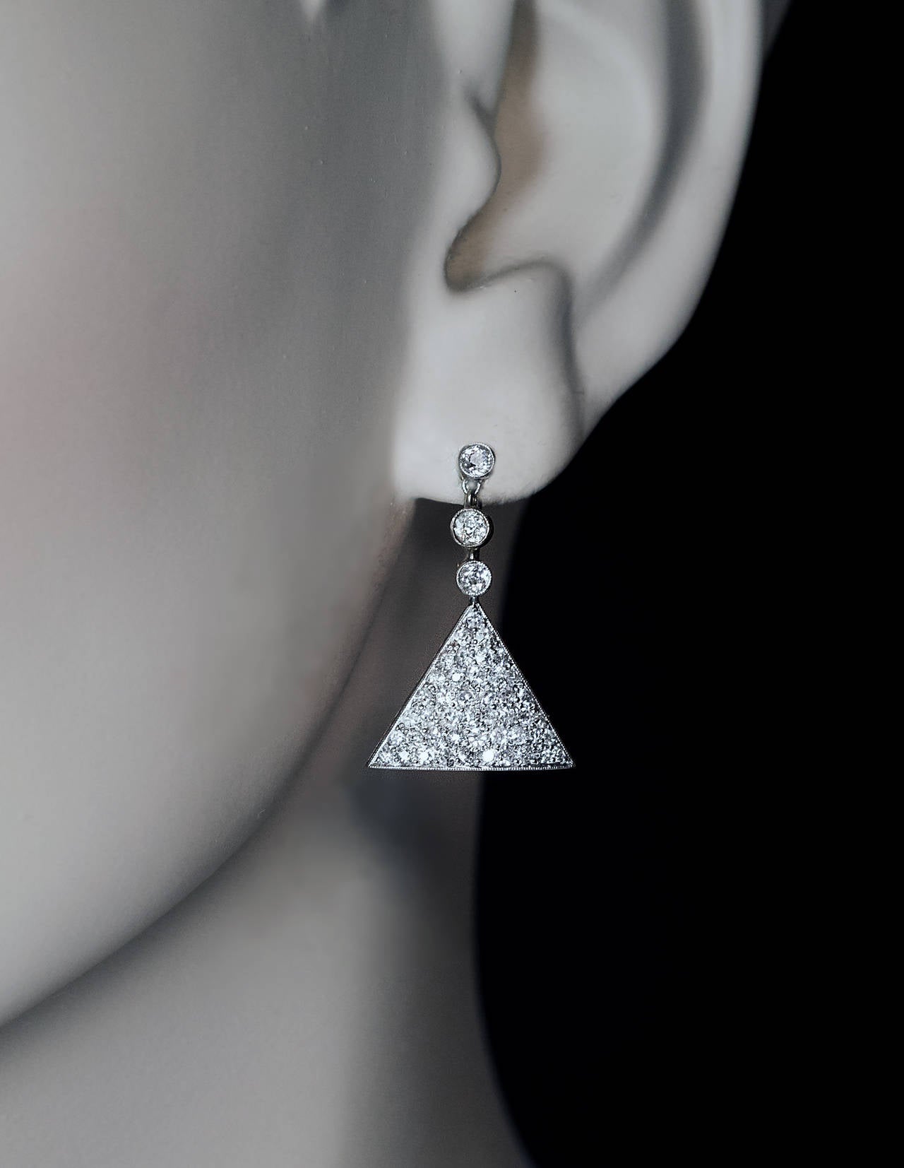 A pair of antique Edwardian era, circa 1910, platinum topped gold earrings pave-set with bright white (F-G color) sparkling old single cut diamonds

Estimated total diamond weight 2.10 ct

Total length 26 mm

Width 16 mm