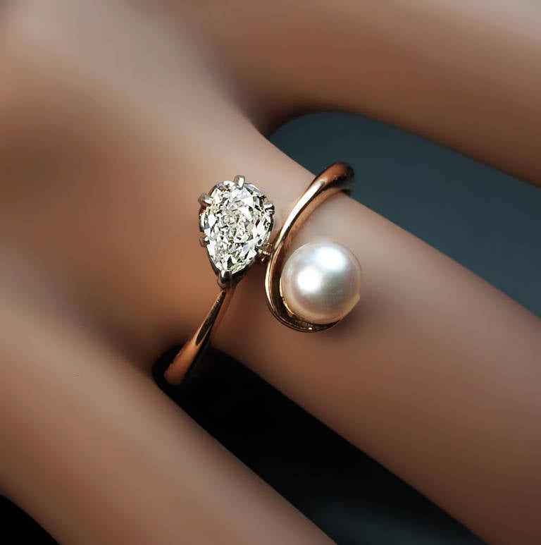 made in Moscow in the 1930s

 a rose gold ring set with a 5.7 mm pearl and an antique pear cut diamond 

 6.1 x 4.5 x 3.1 mm, approximately 0.60 ct

 Marked with 583 gold standard (14K) and maker's mark

 US ring size  6 1/2  (17 mm)