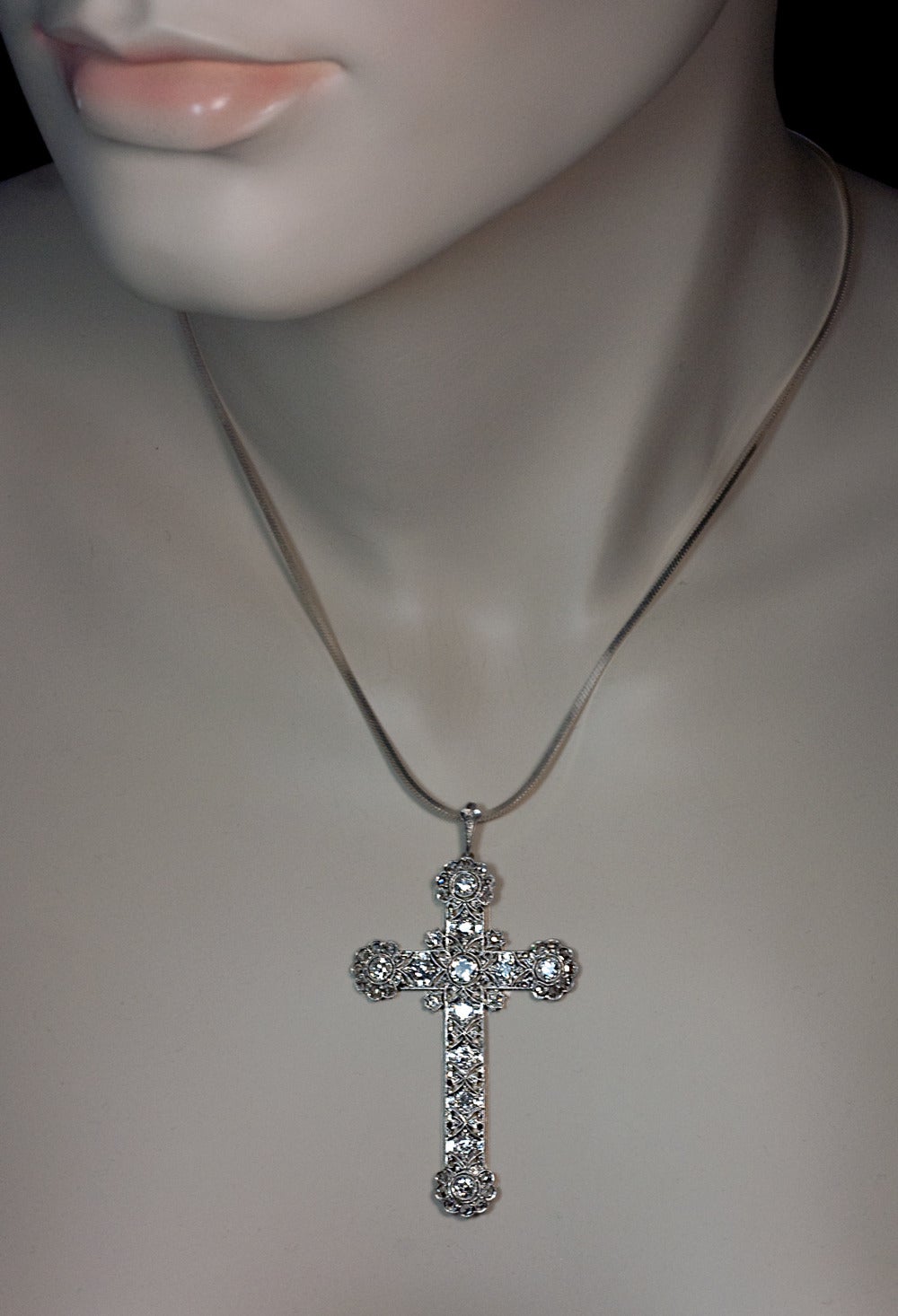 A large handmade platinum milgrain cross of an elaborate saw pierced openwork design set with old European, old single cut and rose cut diamonds 

 Estimated total diamond weight 2.10 ct

 Length with bail - 65 mm (2 1/2 in.)

 Width - 36 mm