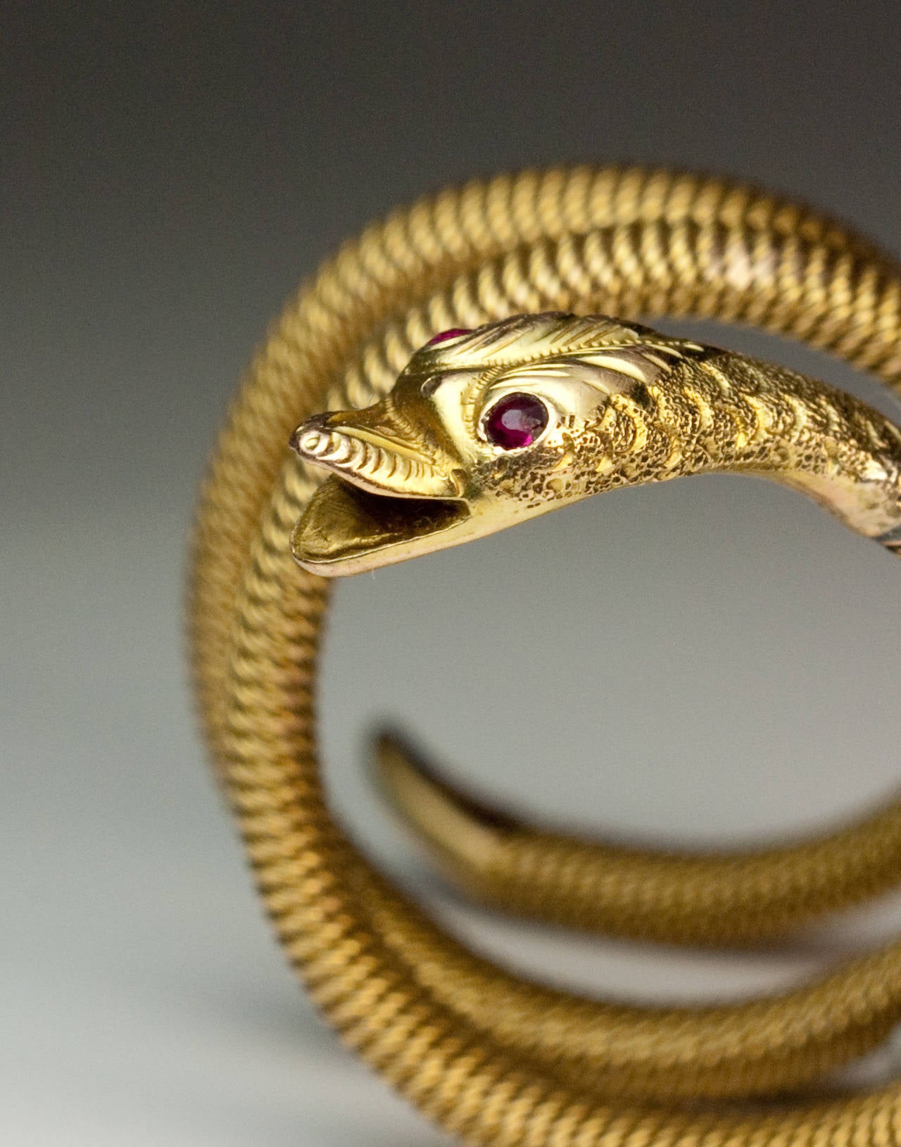 a 14K gold mesh (woven) ring designed as a coiled snake with intricately engraved detailing of the head, eyes set with tiny rubies

 The ring is marked on tail with Russian 1899-1908 import mark.

 Approximate ring size 6 to 6 1/2   (17 mm)