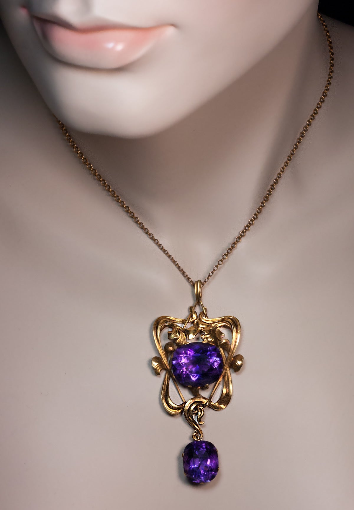 Made in Moscow between 1899 and 1908.

14K gold Art Nouveau pendant of an openwork floral design set with two superb Siberian amethysts - estimated weight 16.41 ct and 9.87 ct

marked with 56 zolotnik gold standard with initials of Moscow assay