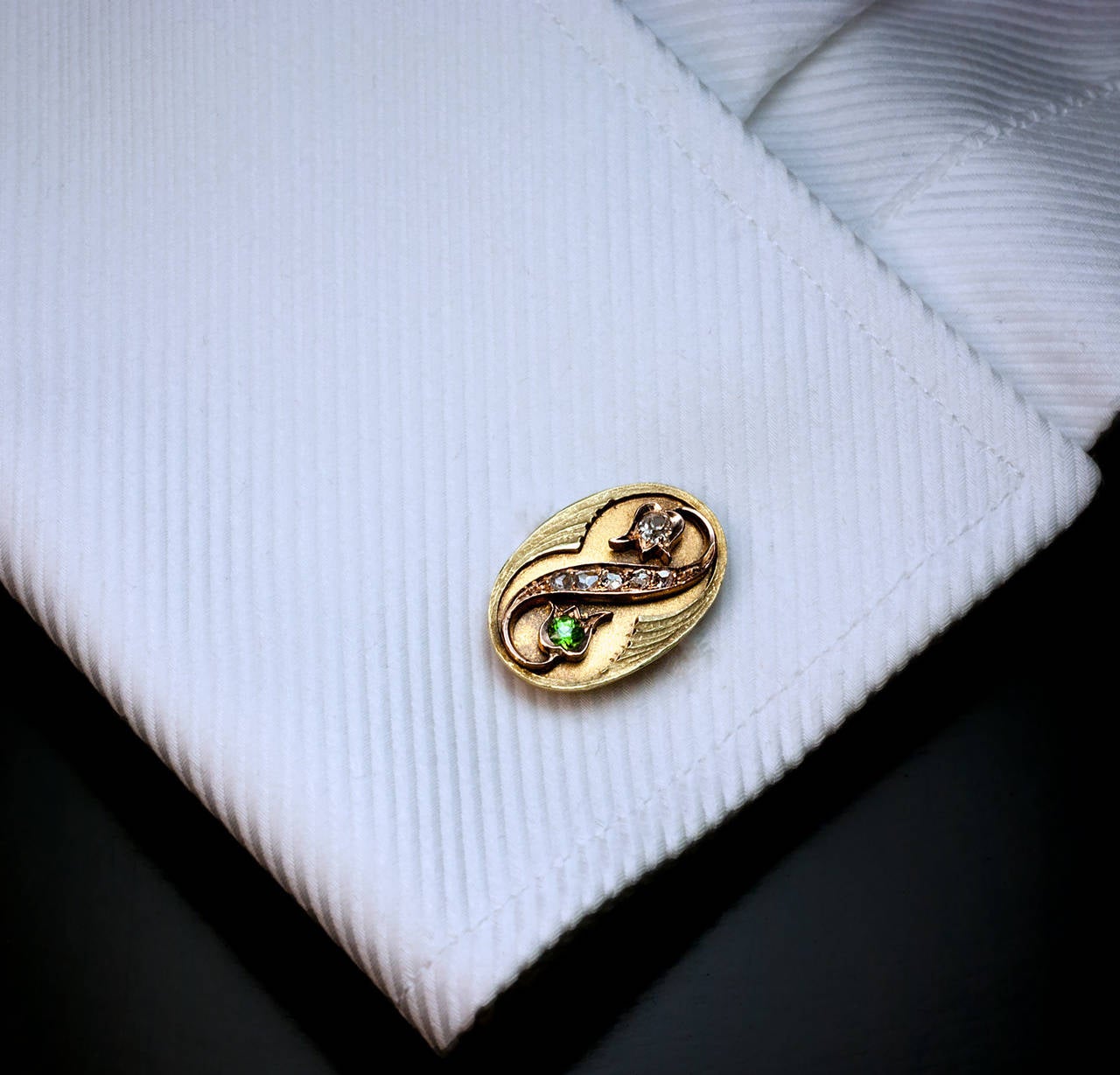 Made in Moscow between 1899 and 1908

Marked with Russian assay mark and maker's initials

Greenish yellow 14K gold cufflinks with applied stylized flowers set with sparkling green Russian demantoids, old mine and old rose cut diamonds

Width