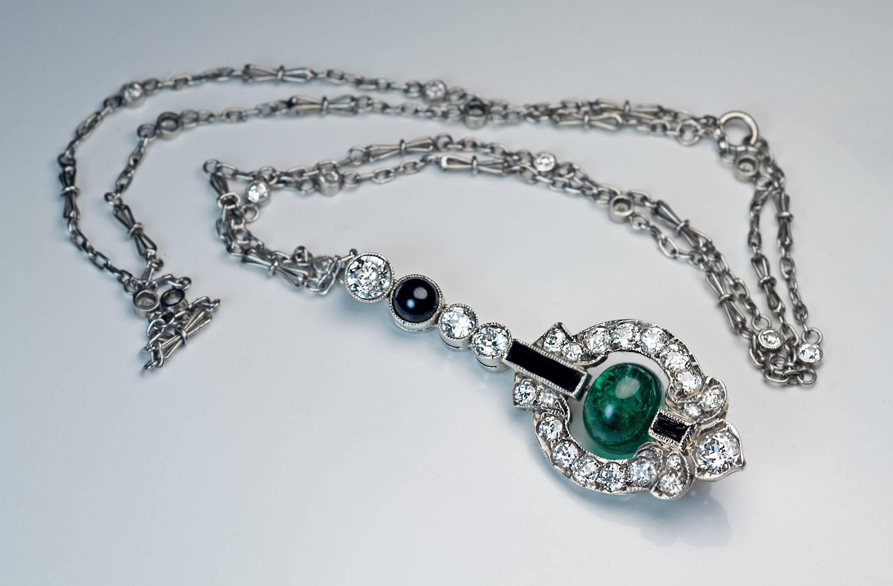c. 1925

a silver topped gold pendant centered with an emerald bead hanging within a diamond and black onyx ornate frame, platinum chain embellished with diamonds

estimated total diamond weight 2.50 ct

length of the pendant (with bail) 42 mm