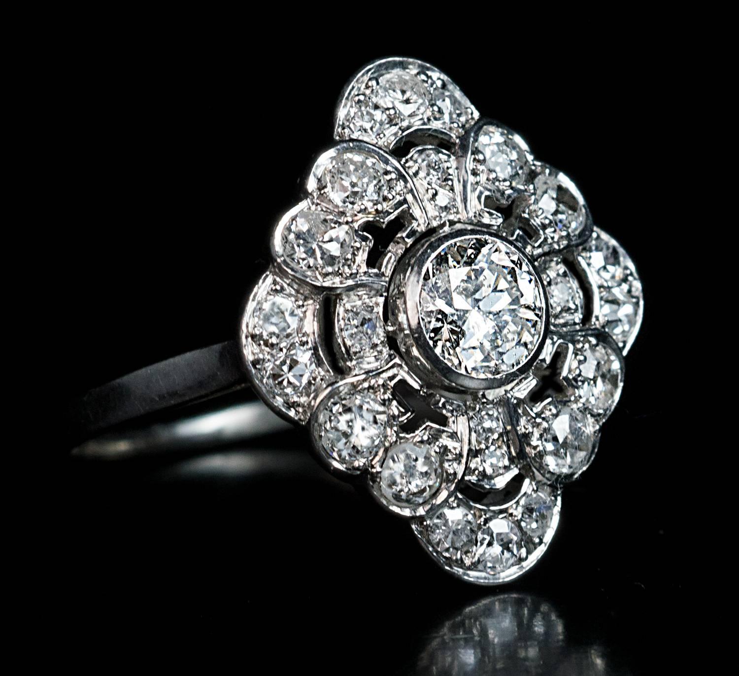 1920s, probably French, marked with lozenge-shaped maker's mark

An openwork platinum ring is set with transitional and old cut diamonds.

The center diamond is approximately 0.60 ct. 

Estimated total diamond weight 1.70 ct

The diamond top