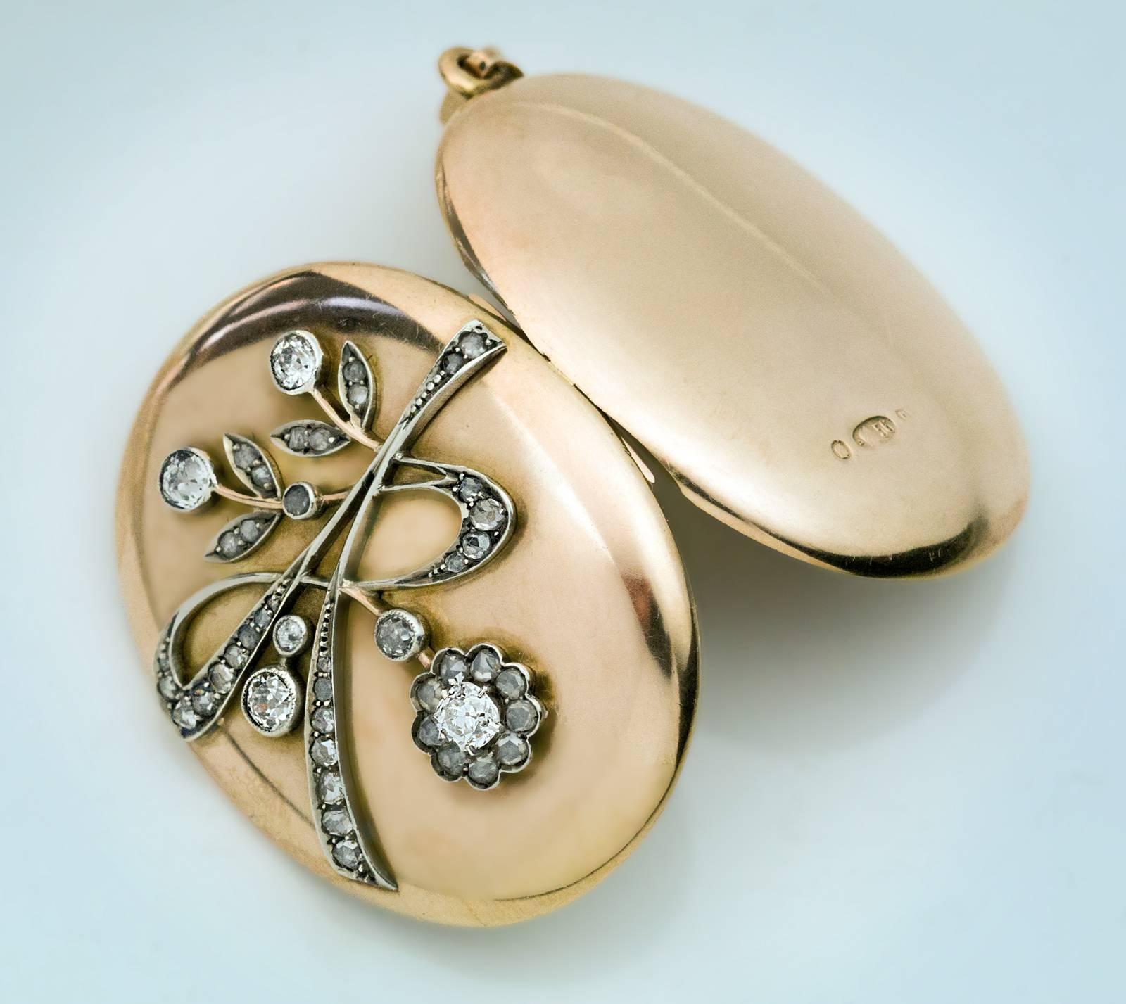Made in Moscow between 1908 and 1917

The locket is embellished with a stylized diamond flower in Art Nouveau taste.The flower is made of silver and set with six brilliant cut diamonds and numerous rose cut diamonds.
The interior is set with a