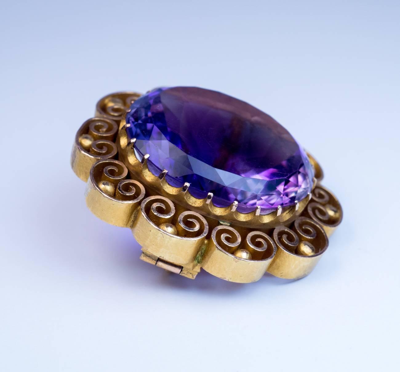Dated 1873

The 14K yellow matte gold brooch features an oval Russian amethyst (24 x 21 x 12.4 mm, approximately 33 carats) surrounded by ornate openwork bezel.

Marked on pin with the date ‘1873’, maker’s initials and 56 zolotnik old Russian gold