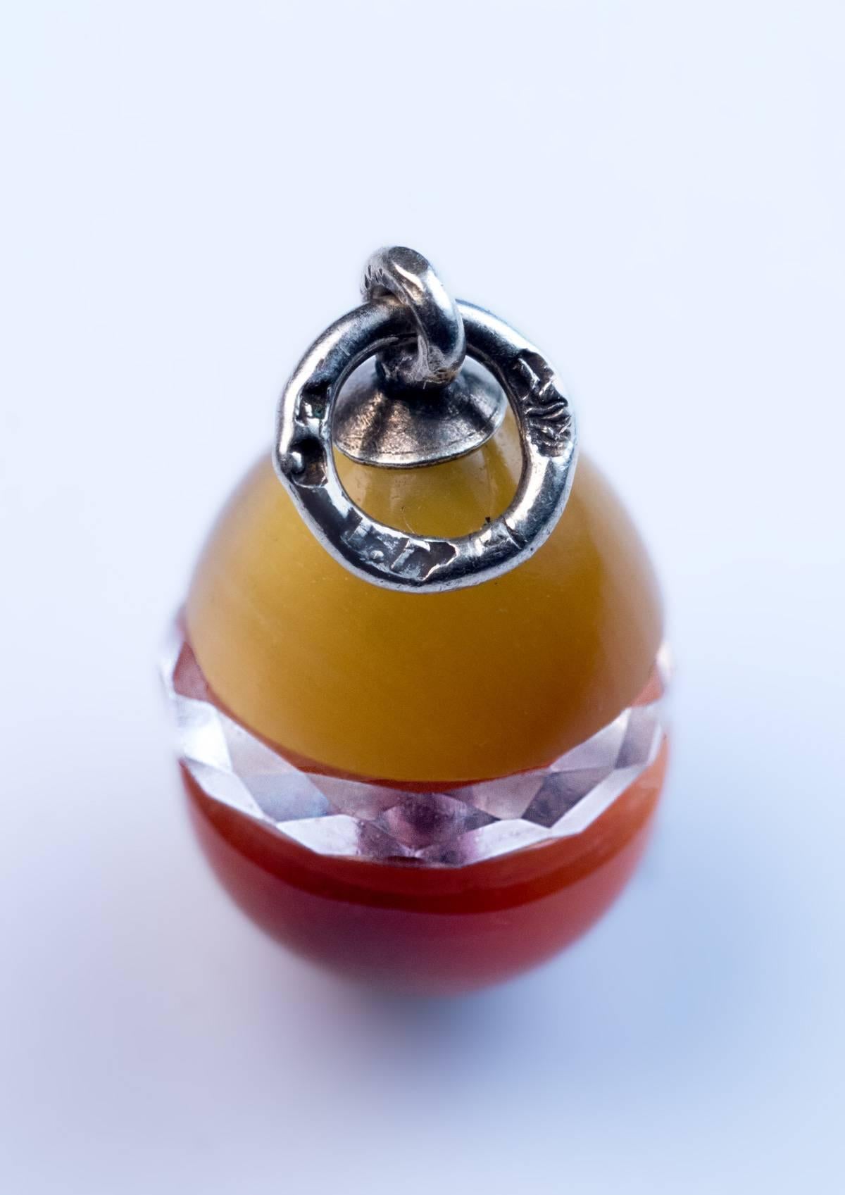 Circa 1890

A highly unusual antique Russian silver mounted cat’s eye egg pendant. The egg consists of two carved chrysoberyls with bold cat’s eye effect (chatoyancy) separated with a faceted rock crystal band.

Marked on the silver suspension