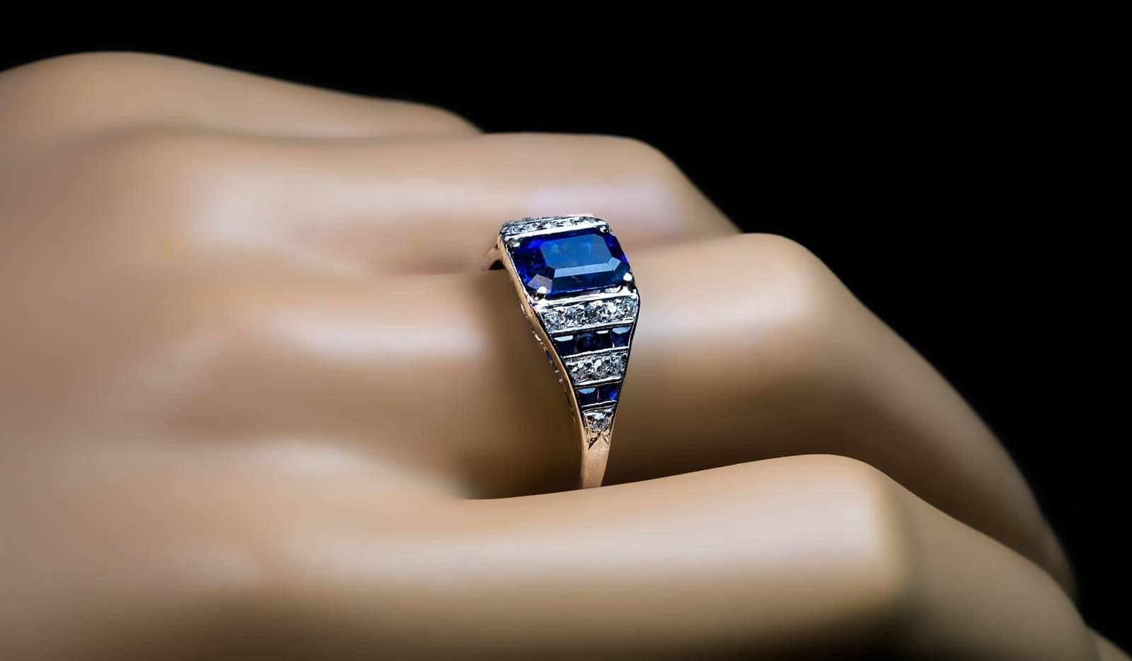 Circa 1920

A platinum hand-crafted ring is centered with an emerald cut natural sapphire (8.2 x 5.85 x 4.4 mm, approximately 2.11 ct) of a beautiful cornflower blue color.

The shoulders of the ring are vertically channel set with old single