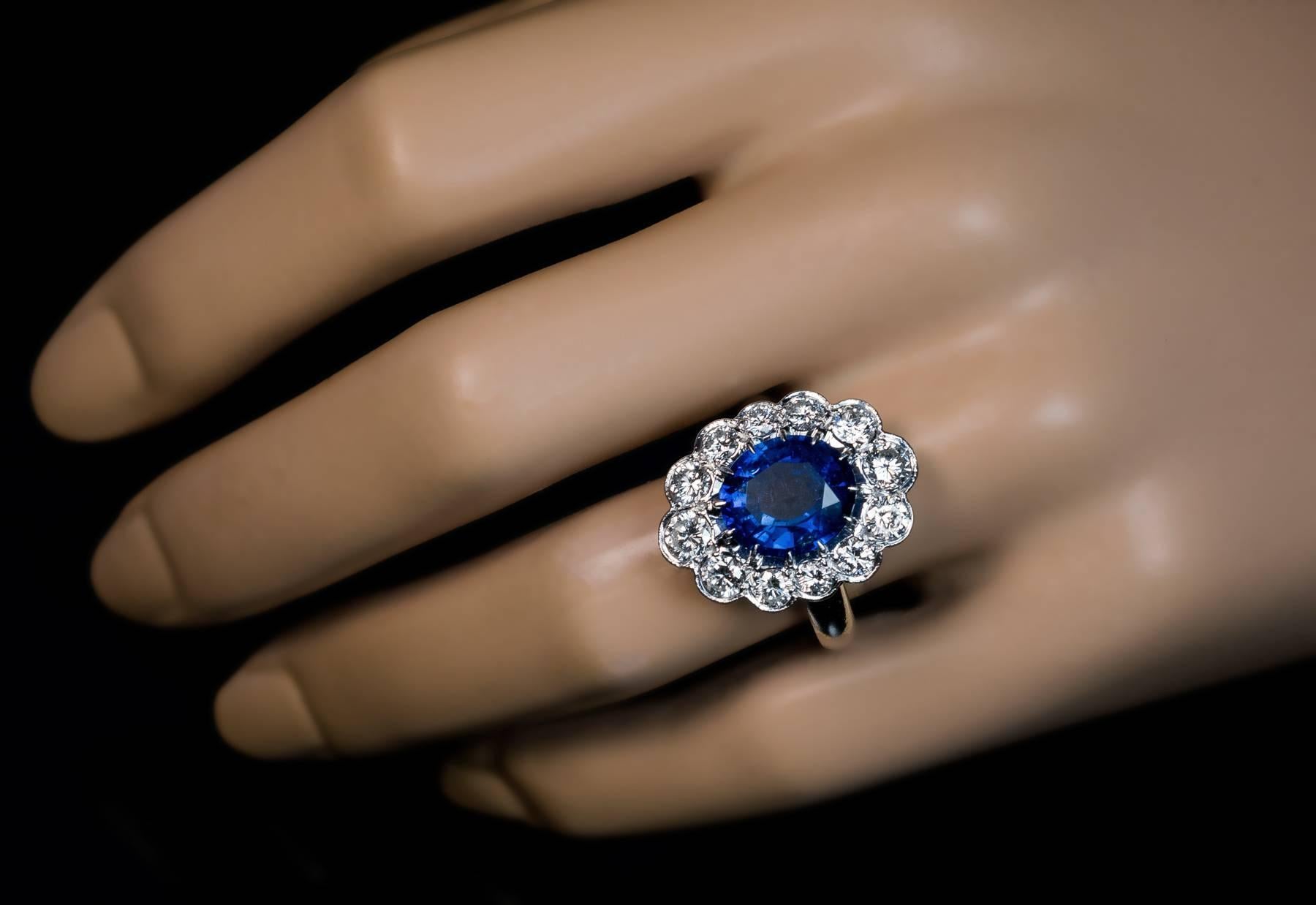 An impressive French cluster ring from the 1940s -1950s.

The handcrafted platinum ring features a natural oval blue sapphire (measuring 10.75 x 9.4 x 4.8 mm, approximately 3.88 ct), framed by twelve bright white brilliant diamonds.
Estimated
