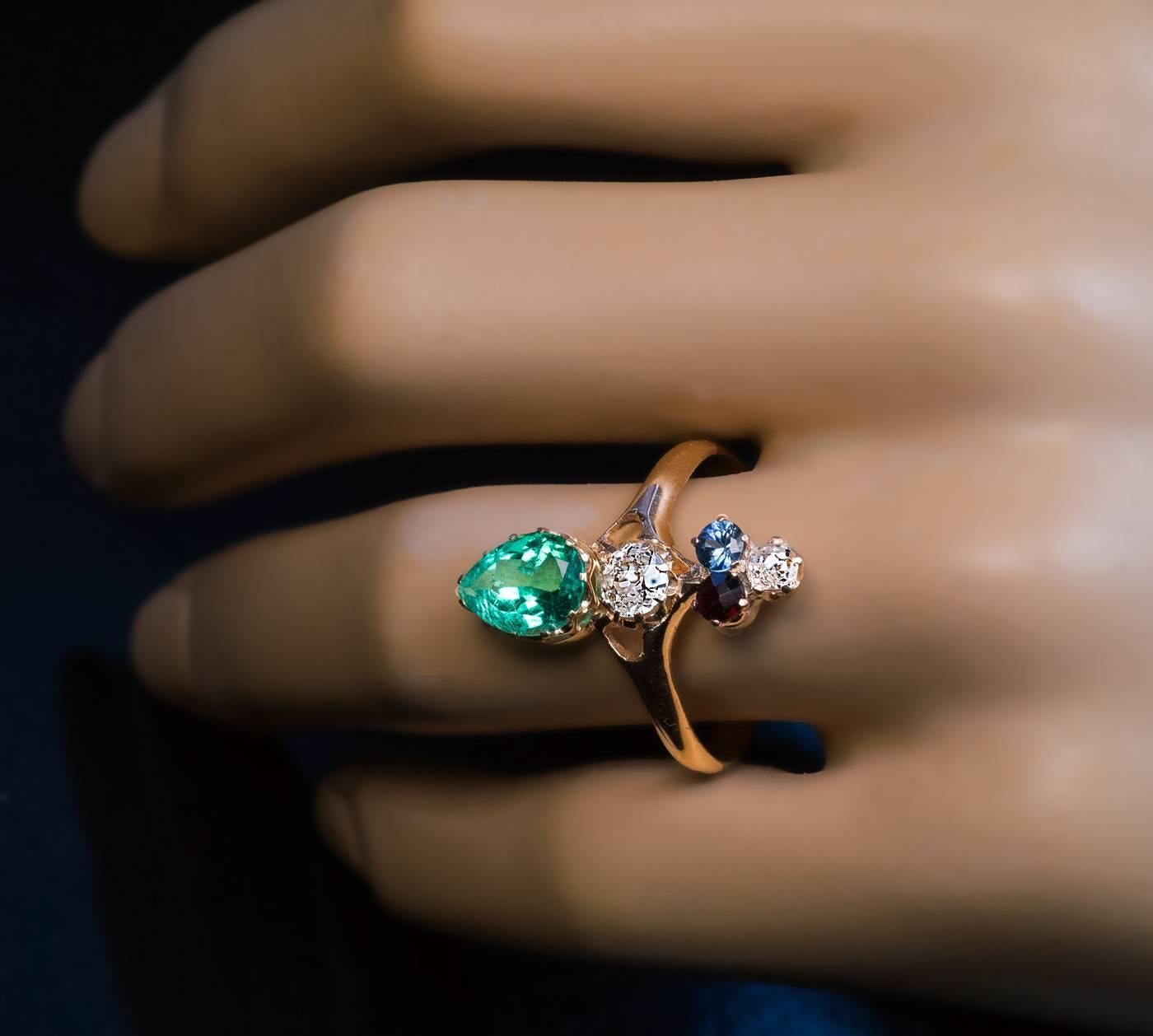 made in Odessa between 1908 and 1917

The 14K gold ring is vertically prong-set with a sparkling pear cut emerald (8.8 x 6.5 x 4.85 mm, approximately 1.10 ct), an old European cut diamond (approximately 0.30 ct), a red garnet, a blue sapphire and