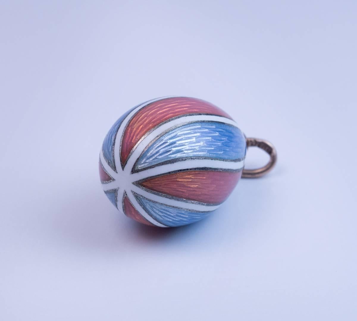 Made in St. Petersburg between 1908 and 1917

A very fine and rare original miniature egg pendant by Peter Carl Faberge, Imperial jeweler to the Tsars.

The egg is covered with delicate sky blue and salmon pink guilloche enamels in a spiral