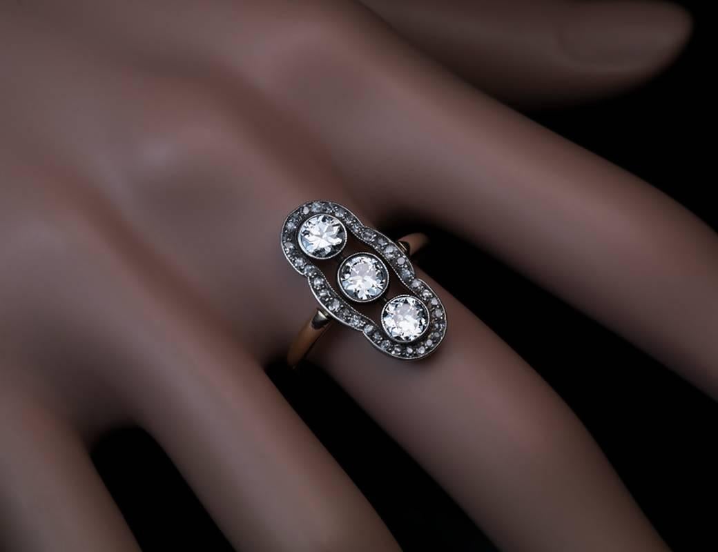 Made in Moscow between 1908 and 1917

This elegant diamond ring is hand-crafted in silver over 14K gold by a prominent Moscow jeweler of the period Feodor Lourie.  The ring is vertically bezel-set with three bright white and sparkling old European