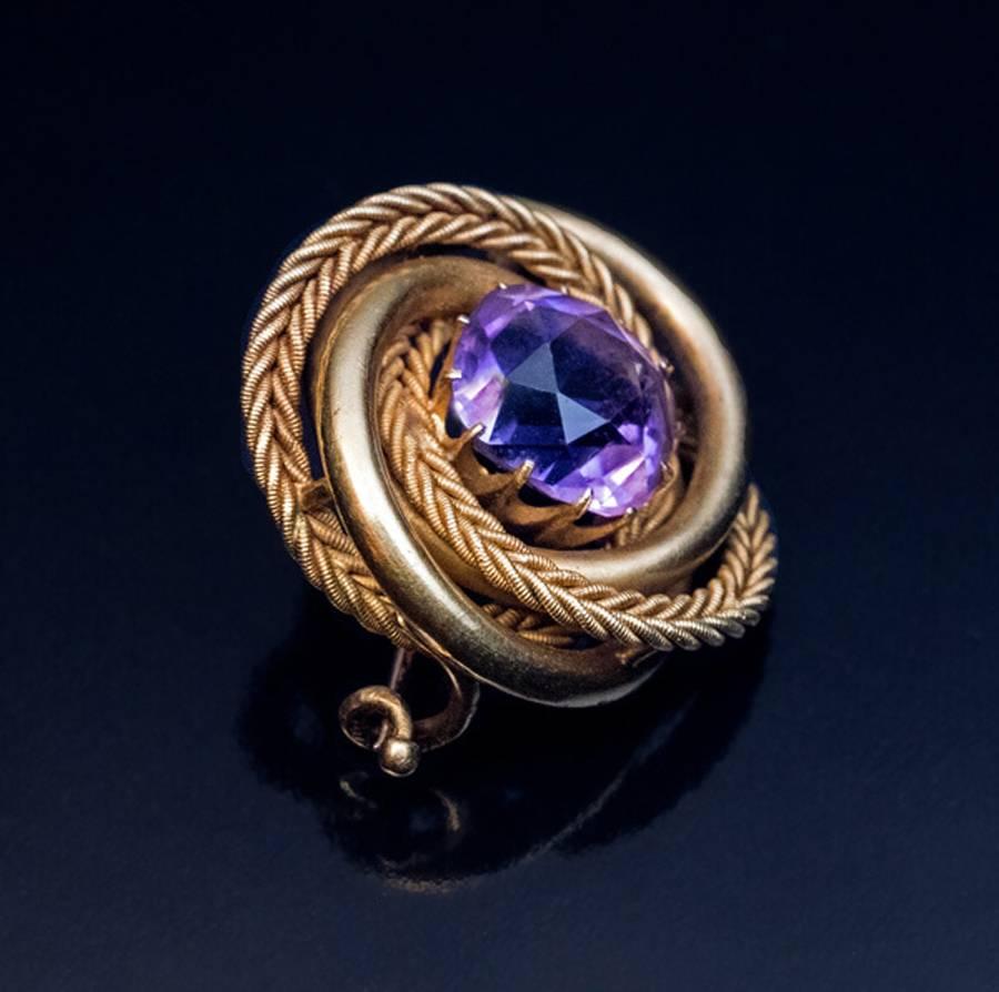 Made in St. Petersburg between 1904 and 1908

A 14K gold love knot brooch is set with a cushion cut light purple sparkling Siberian amethyst (10.8 x 10.1 x 7.6 mm, approximately 4.83 ct).

The brooch is marked on pin guard with 56 zolotnik old