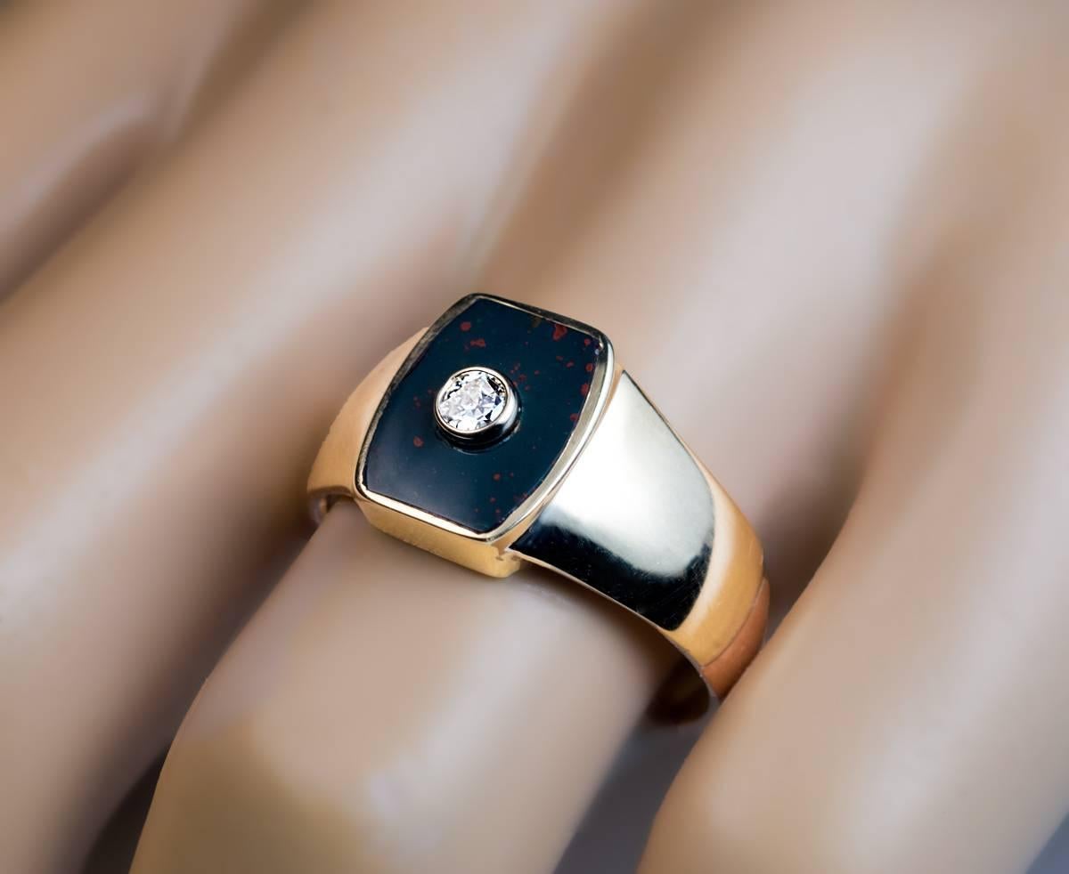 Made in St. Petersburg, circa 1910

A yellow and rose 14K gold ring is set with a flat heliotrope ( a variety of chalcedony, also known as bloodstone) plaque highlighted by a sparkling bezel-set old European cut diamond (approximately 0.12 ct).