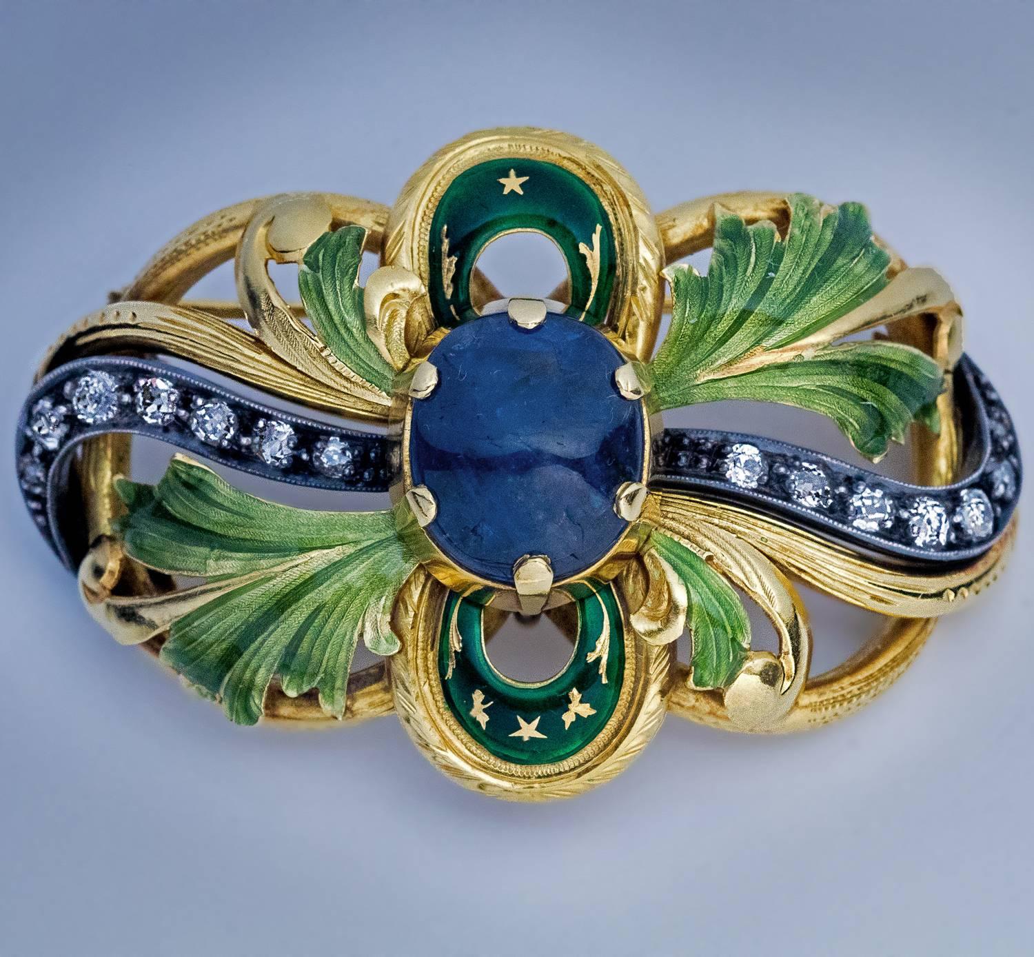 Original antique Art Nouveau partially enameled openwork gold & silver brooch / pin, circa 1915, centered with a large cabochon cut sapphire (approximately 6.55 ct), flanked on both sides by a scrolling row of old European cut diamonds set in silver